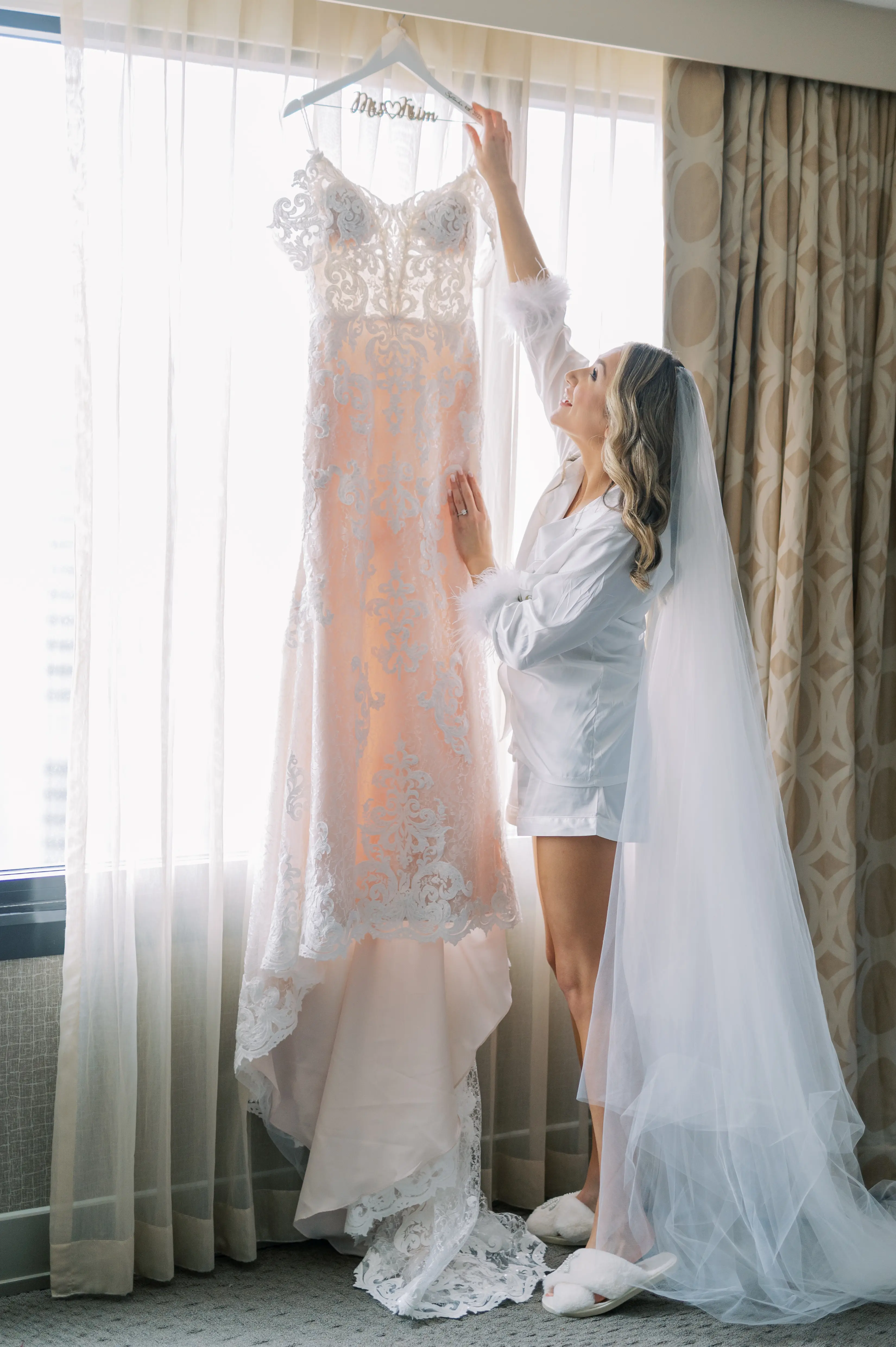 Bride Wearing A Lace Sheath Wedding Gown Named Tuscany Lynette By Maggie Sottero Bride Looking At Dress