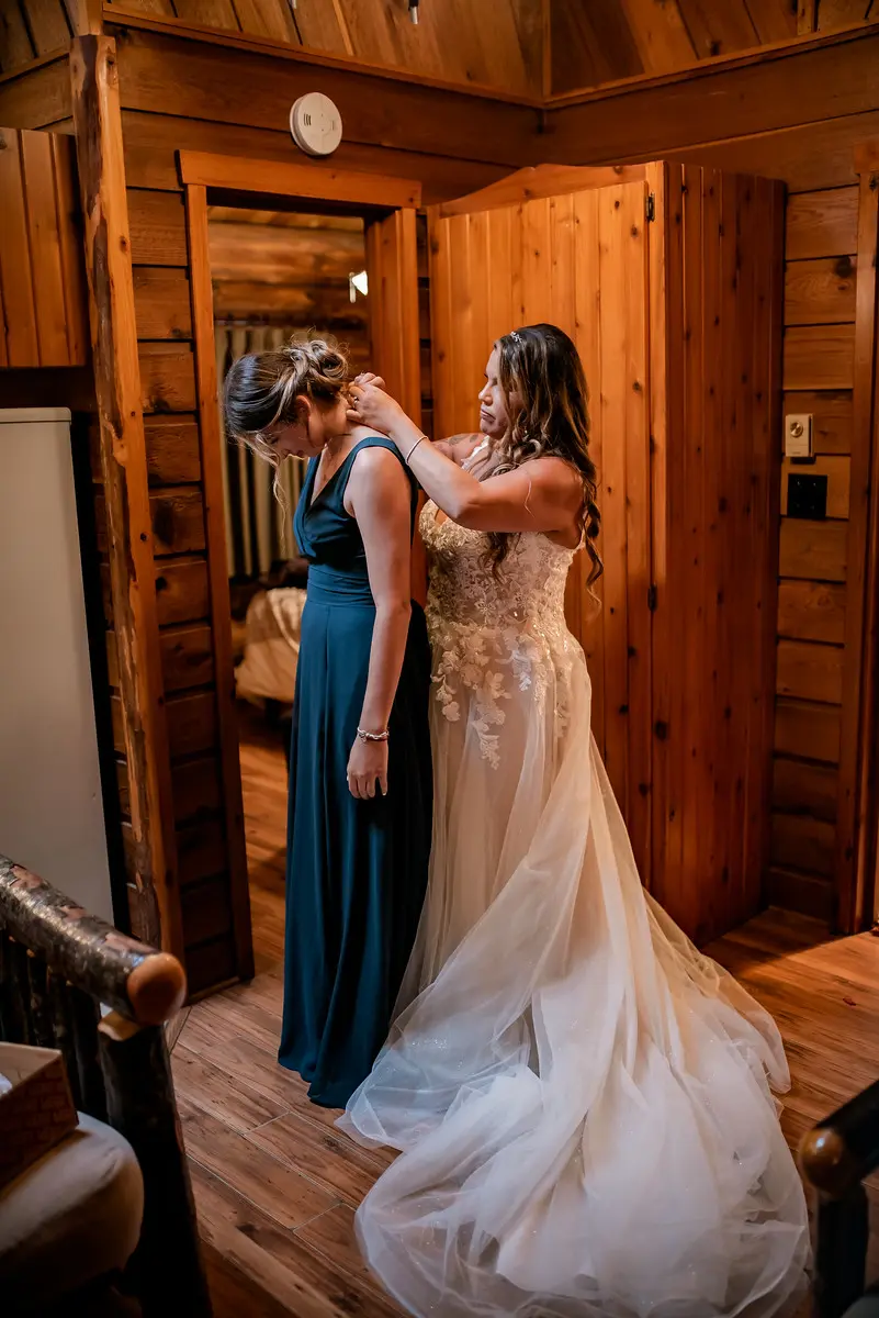 Bride wearing Boho Wedding Dress called Stevie by Maggie Sottero helping her MOH get ready