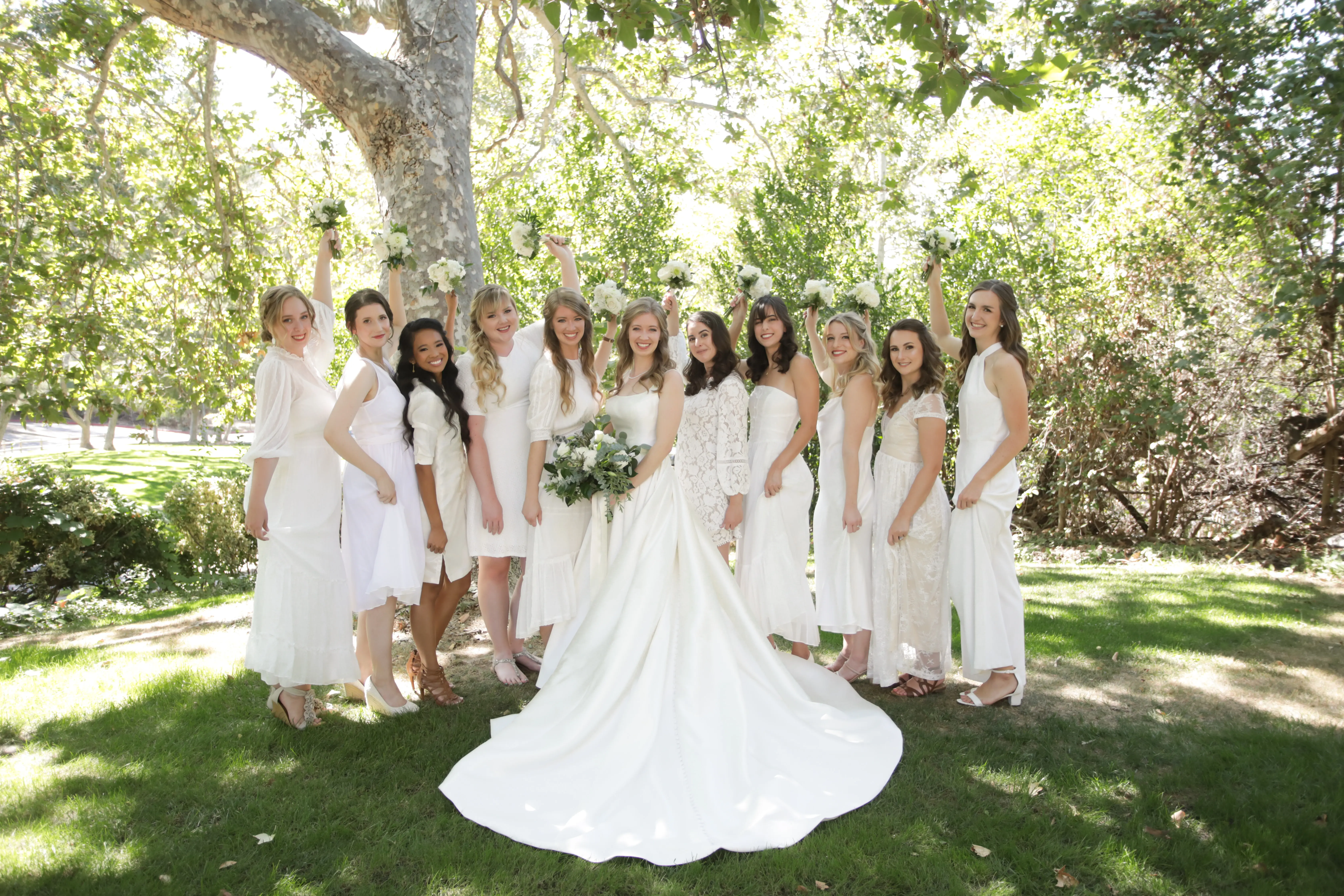 Bride wearing Simple Ballgown Wedding Dress called Selena by Maggie Sottero with her bridesmaids in white dresses