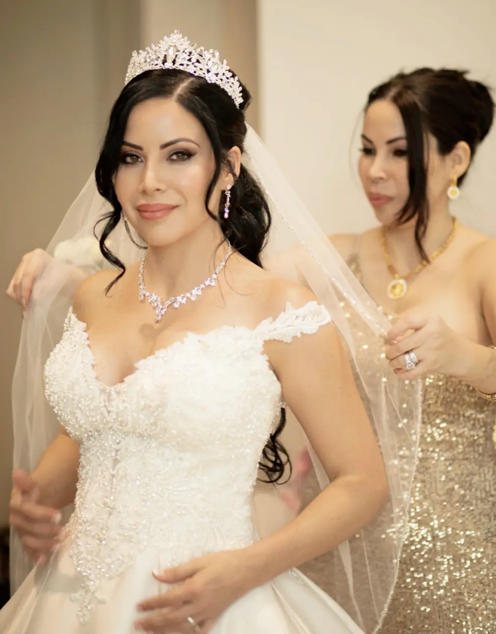 Bride wearing elegant satin ballgown called Kimora by Sottero and Midgley with bridesmaid