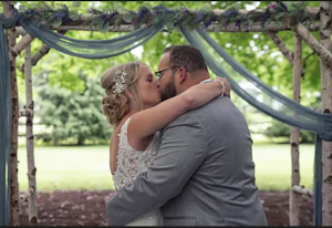 Bride with groom wearing lace crepe wedding dress
