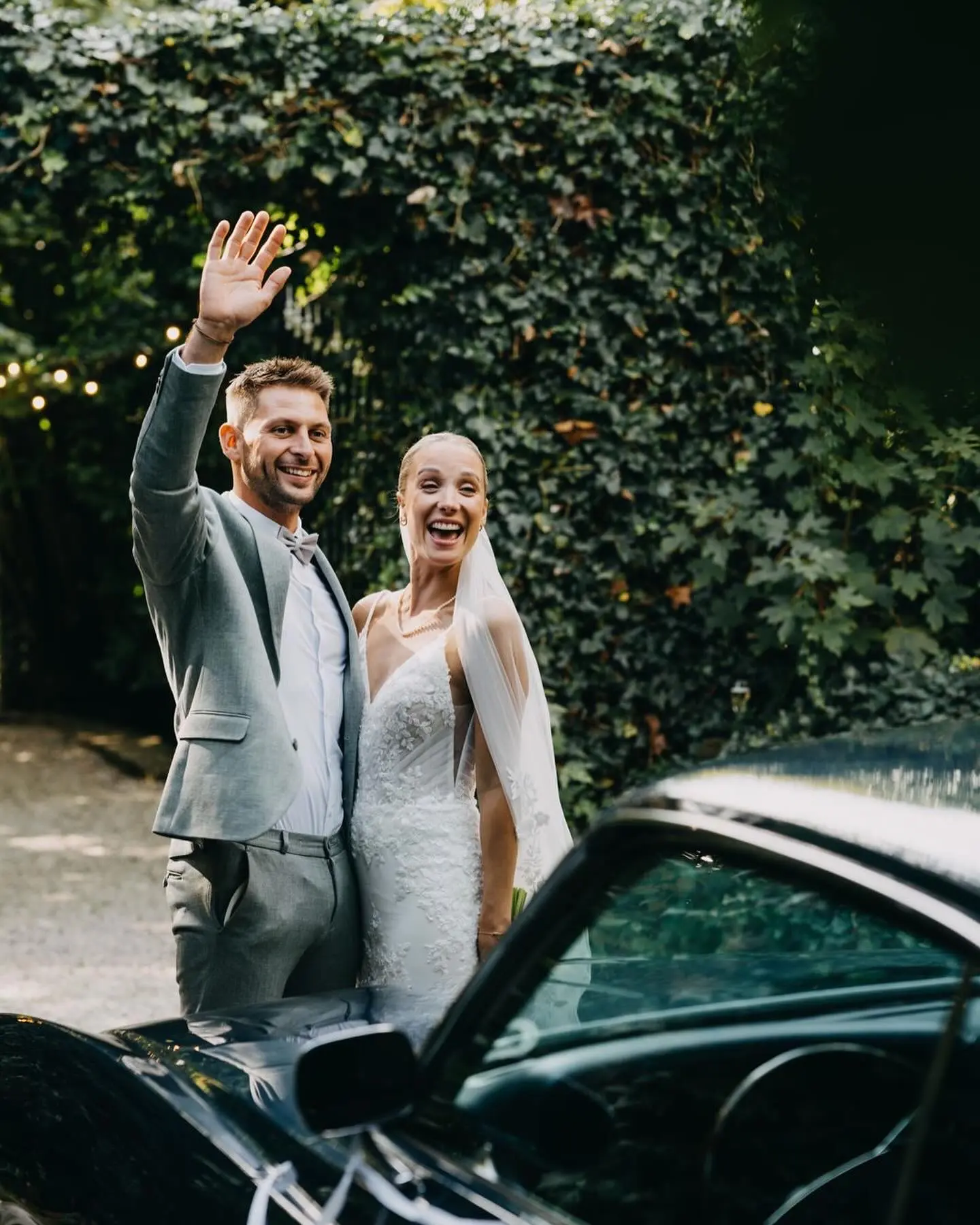 Bride wearing Fontaine by Maggie Sottero waving with her husband