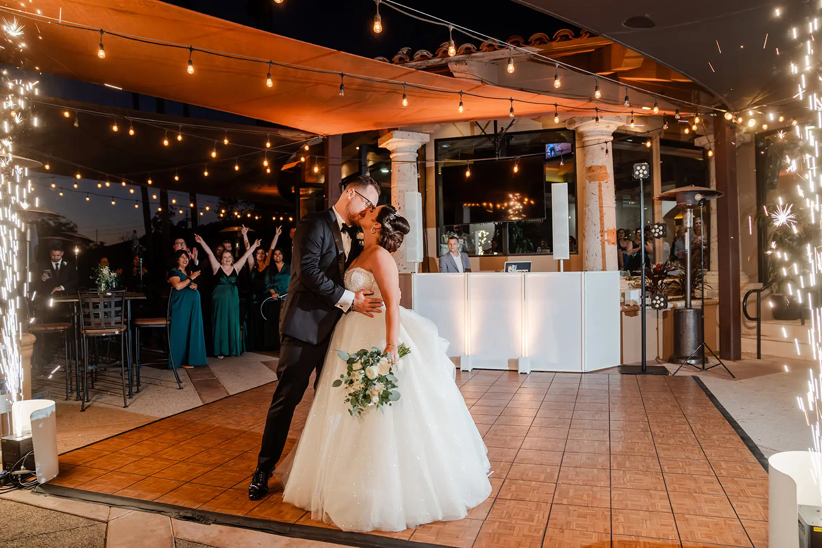 Bride wearing Elton wedding dress by Sottero and Midgley kissing her husband