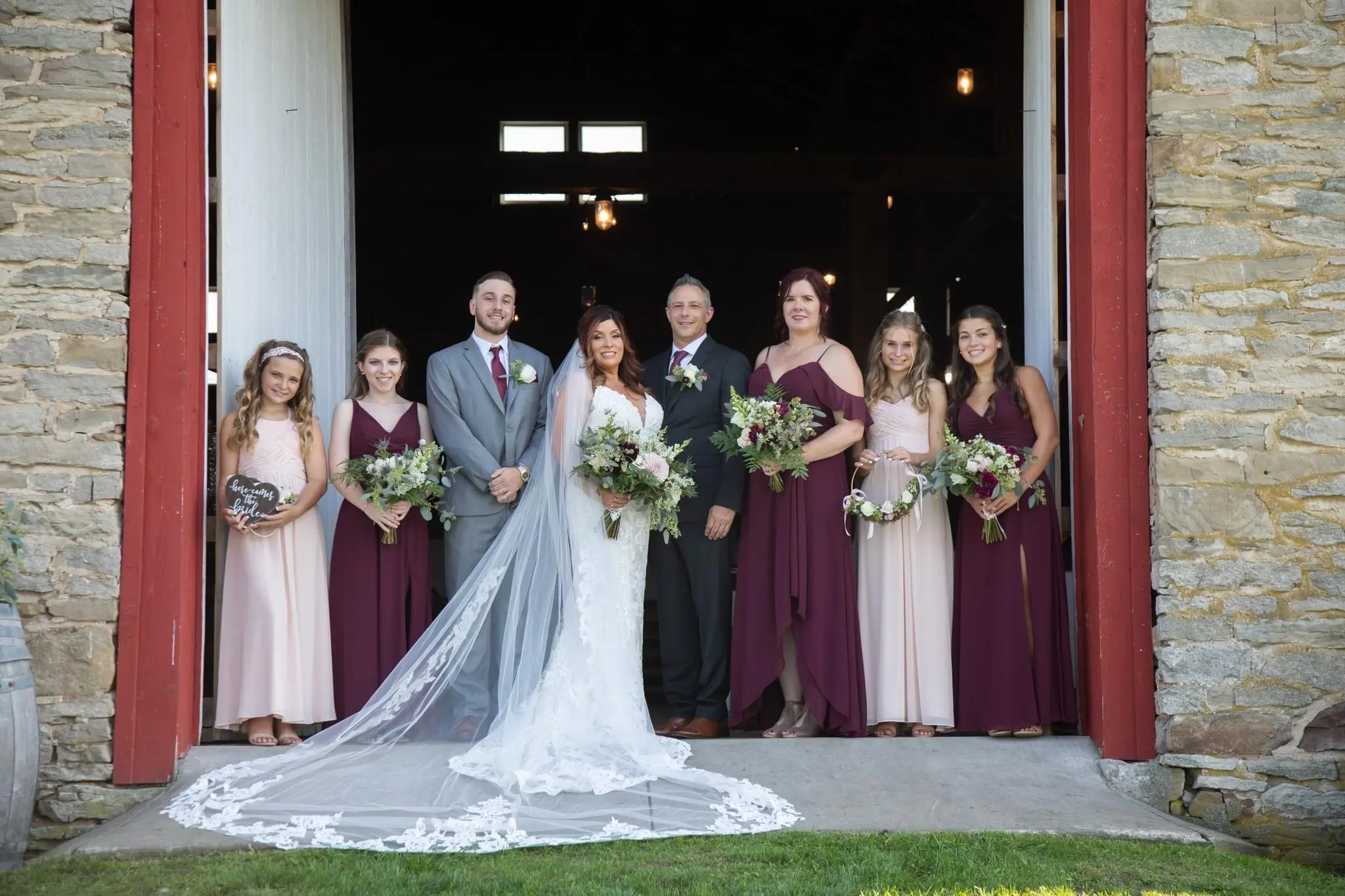 Bride Wearing Sexy Mermaid Wedding Dress Called Tuscany By Maggie Sottero With Groom And Wedding Party Holding Flowers
