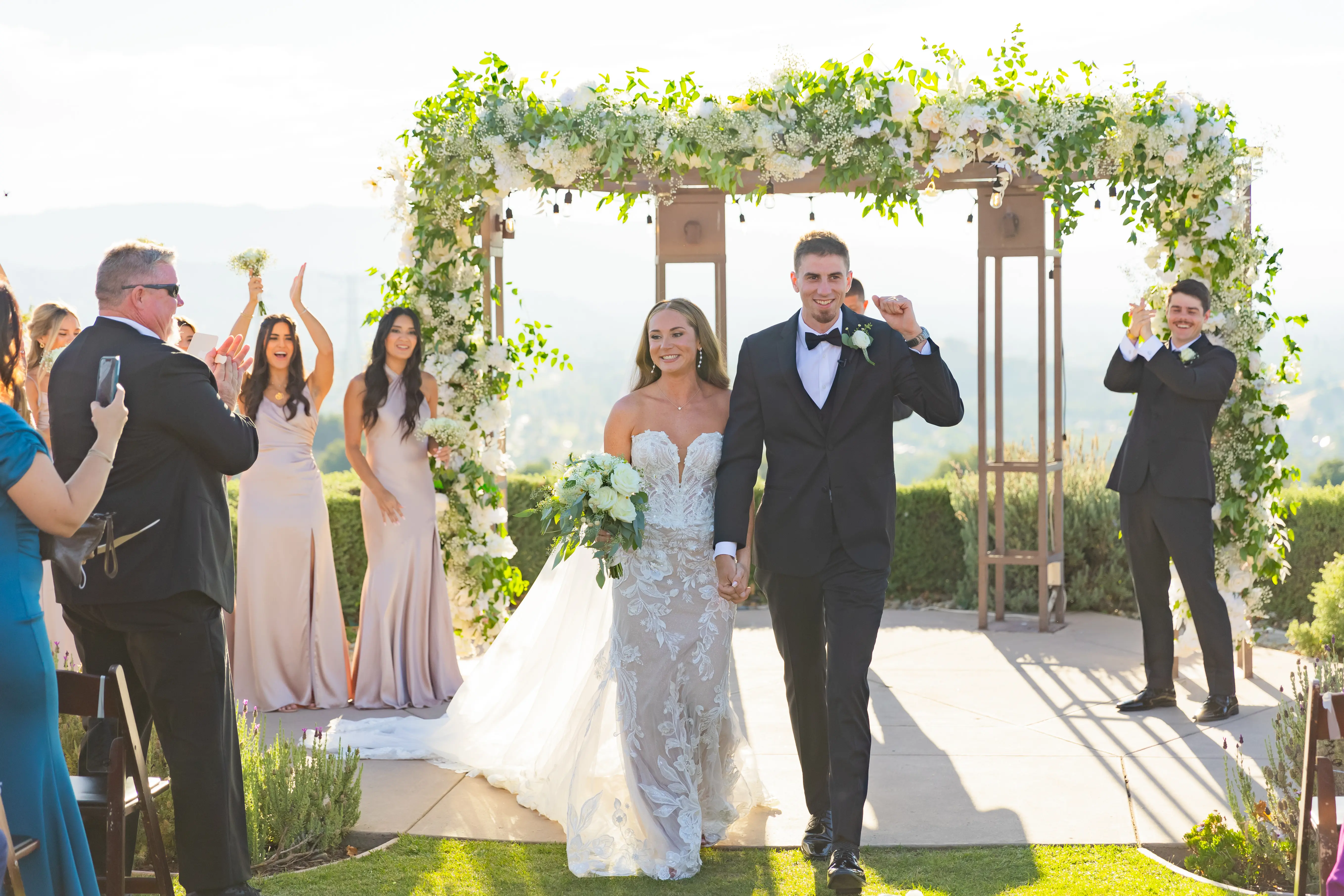 Bride Wearing Lace Fit-n-flare Wedding Dress Called Nyjah By Sottero And Midgley Walking With Groom