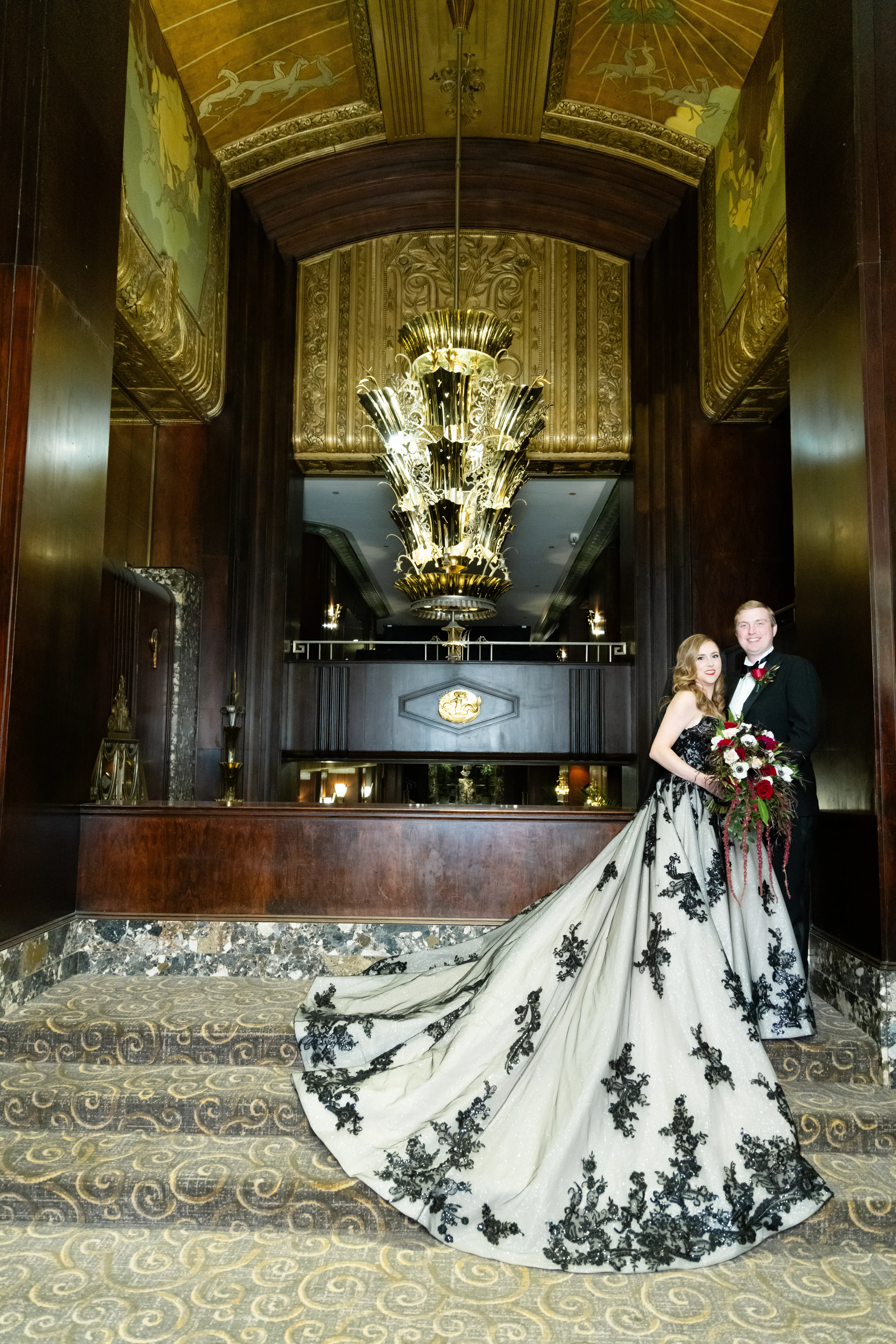 Bride wearing Norvinia wedding dress by Sottero and Midgley standing with her husband