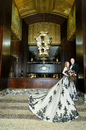 Bride wearing Norvinia wedding dress by Sottero and Midgley standing with her husband
