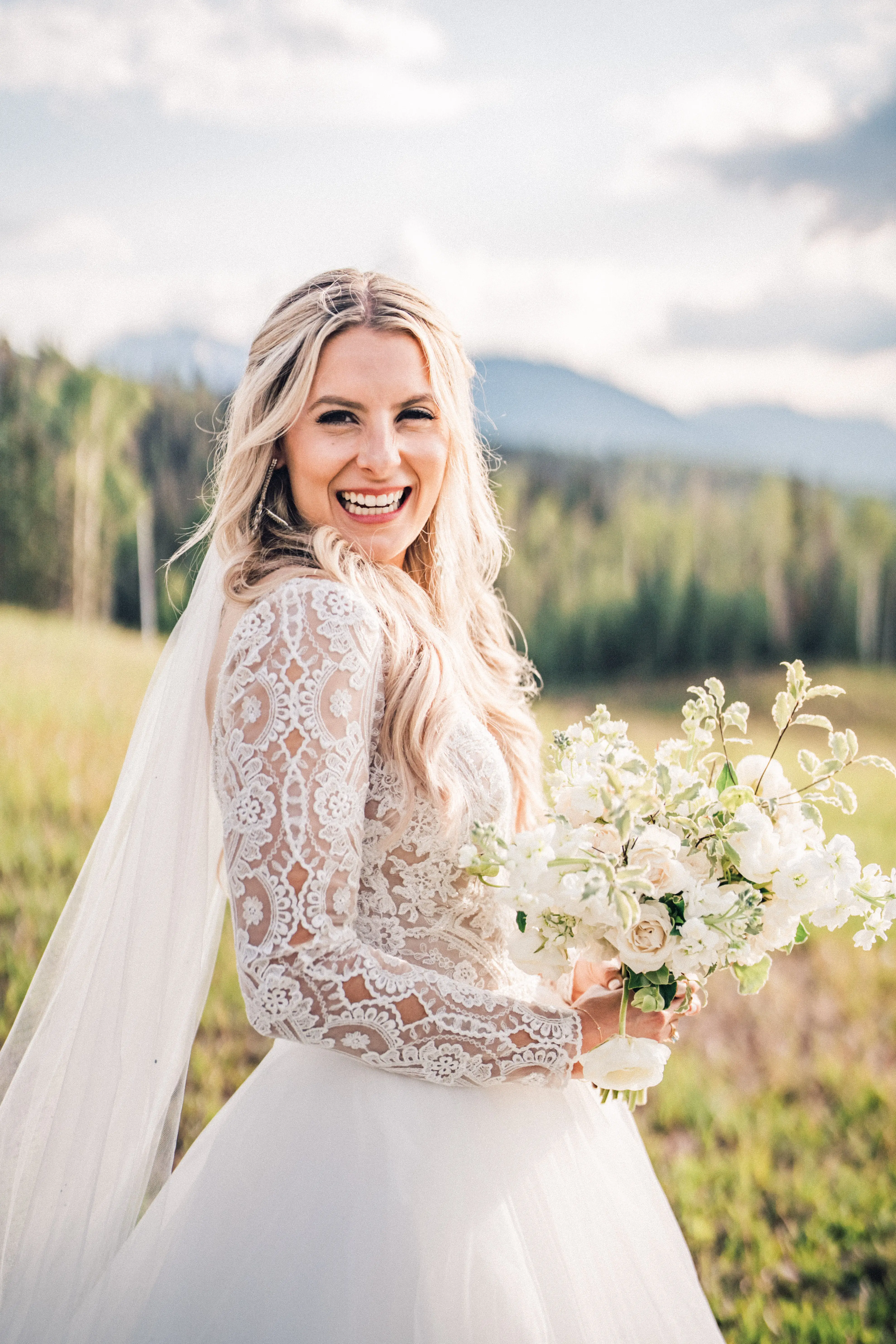Bride wearing long sleeve lace ballgown wedding dress