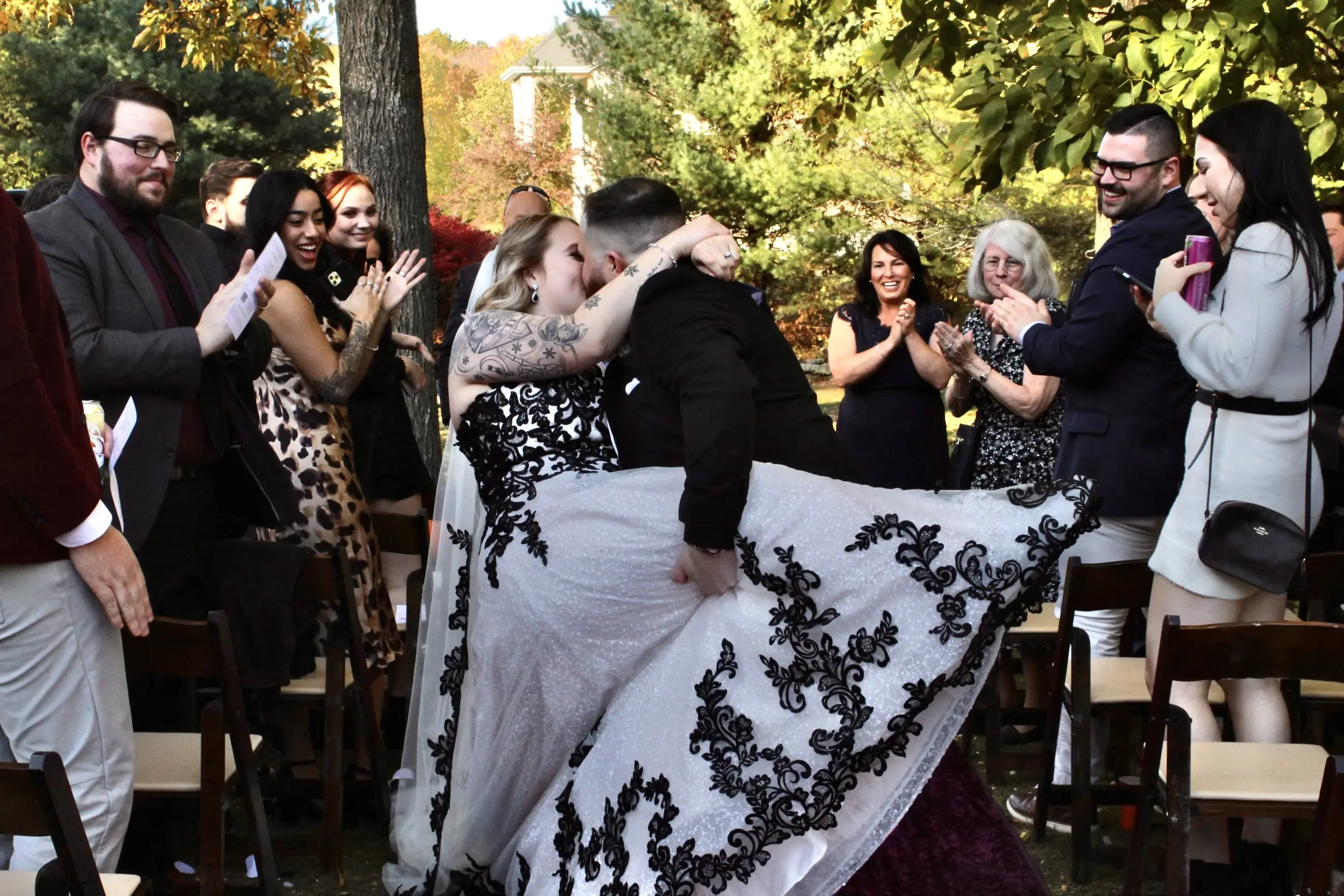 Groom Kissing Bride Wearing Black Lace Wedding Dress Called Tristyn By Maggie Sottero