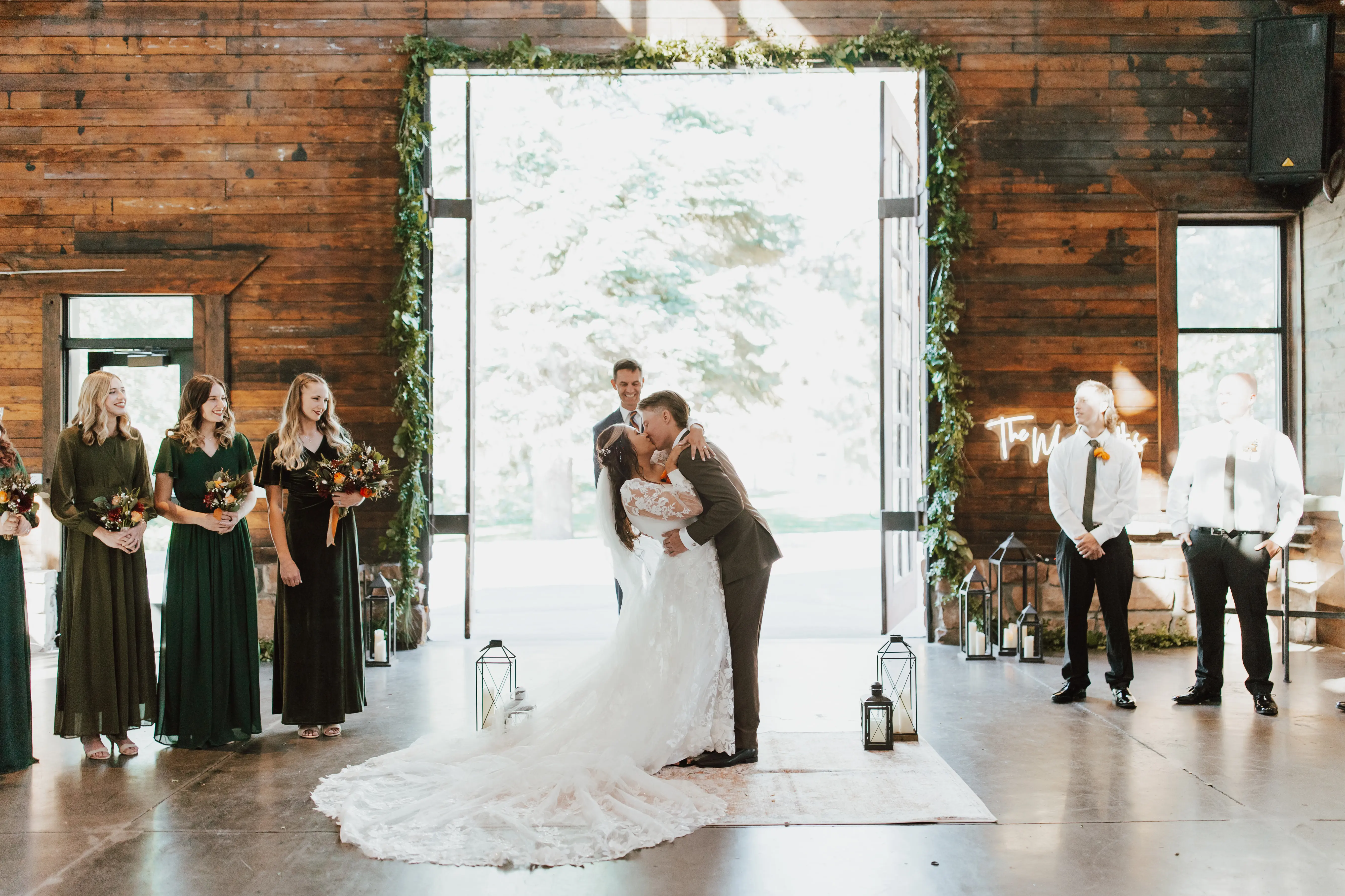 Bride And Groom Share First Kiss. Bride Wearing Sparkly Modern Ball Gown Wedding Dress With A Mikado Bodice Called Greer By Maggie Sottero
