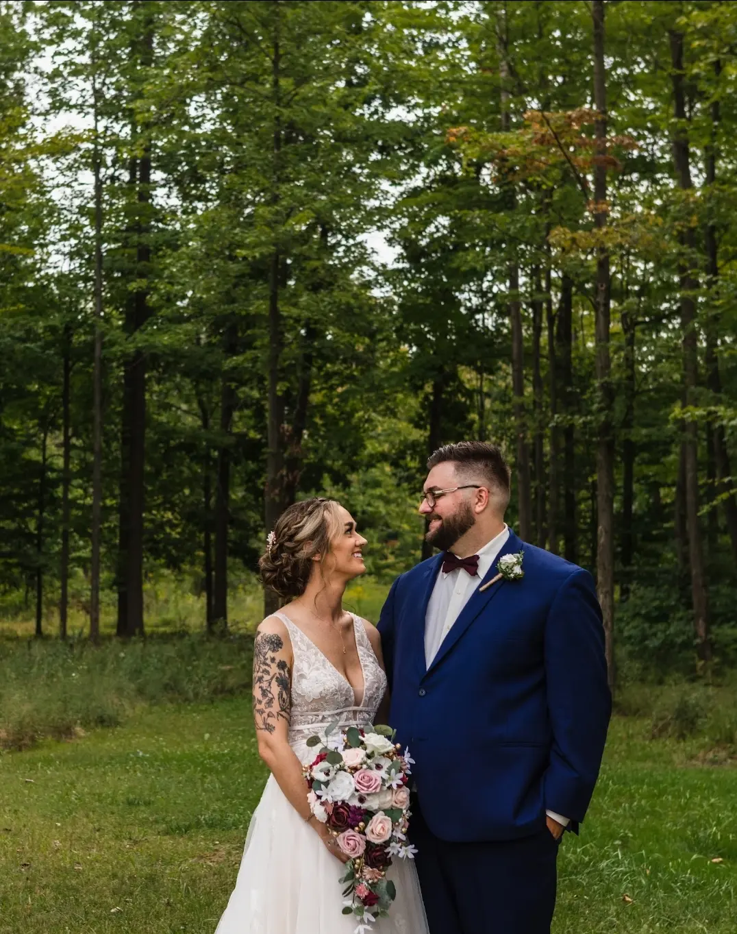 Bride wearing Boho Lace Wedding Dress called Raelynn by Rebecca Ingram with the groom in the forest