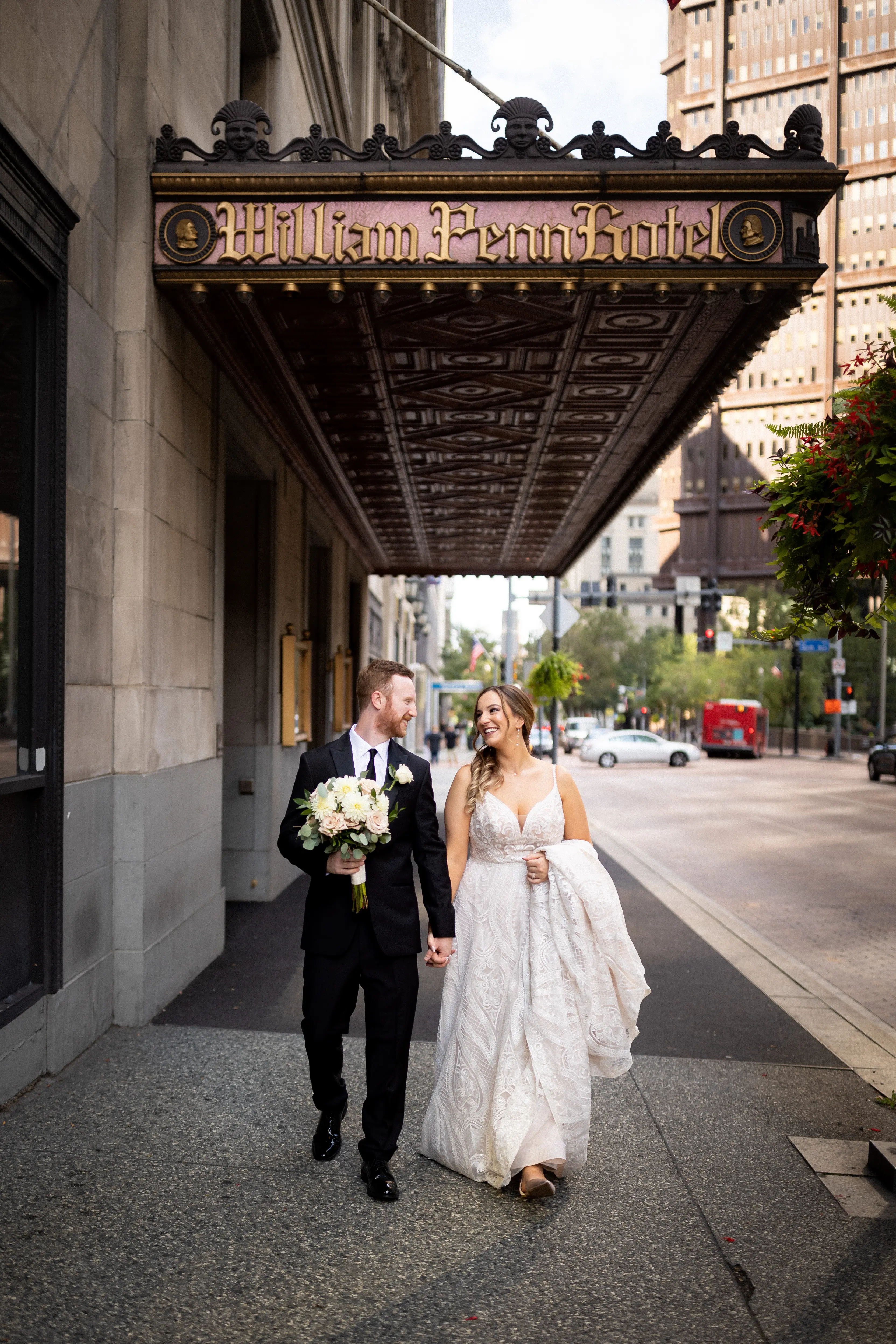 Bride Wearing Glam Princess A-Line Wedding Dress Called Roxanne By Sottero And Midgley Holding Hands with Groom