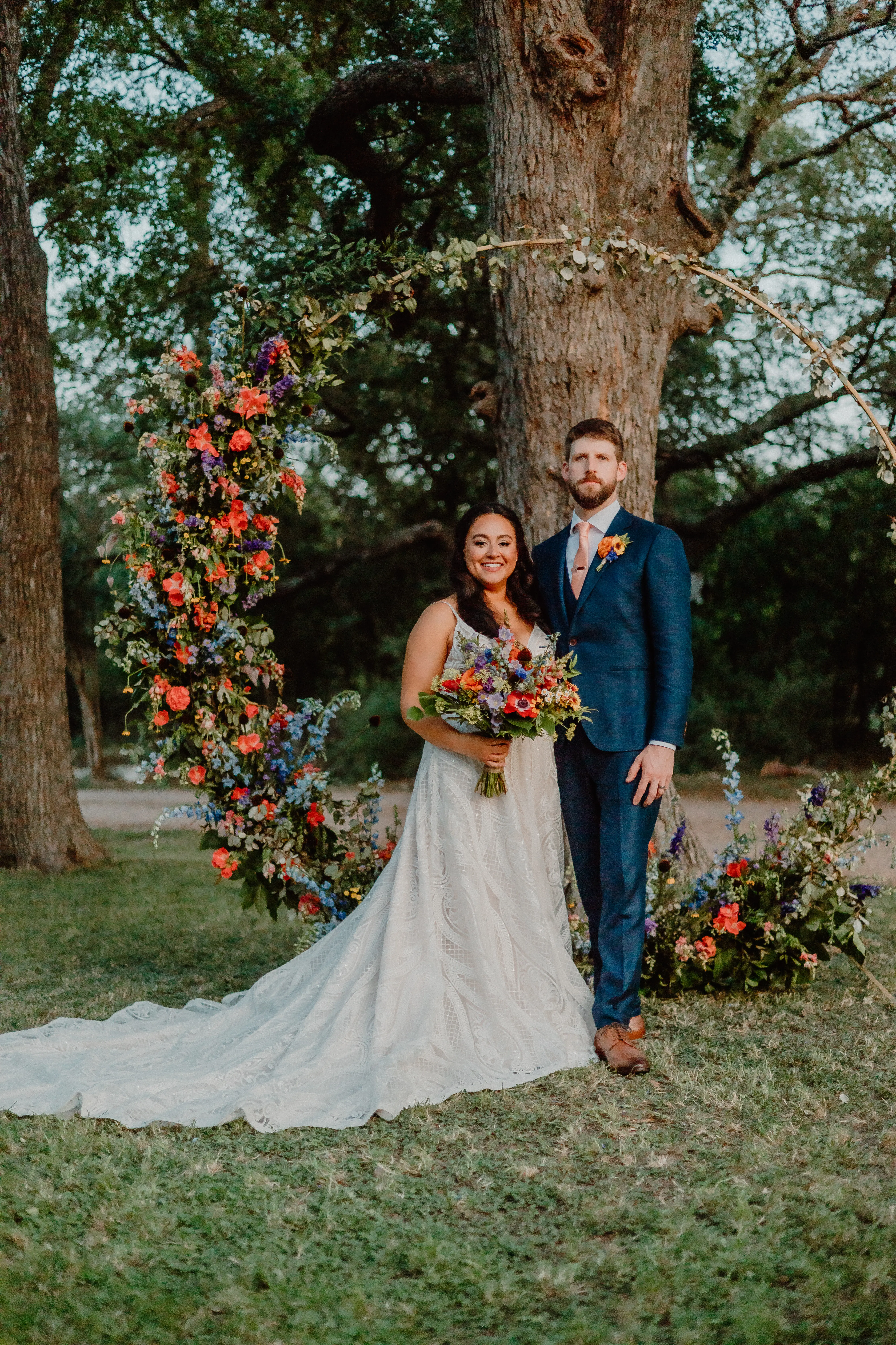 Groom Posing With Bride In Boho Lace Wedding Dress Called Roxanne By Sottero And Midgley With Colorful Flowers