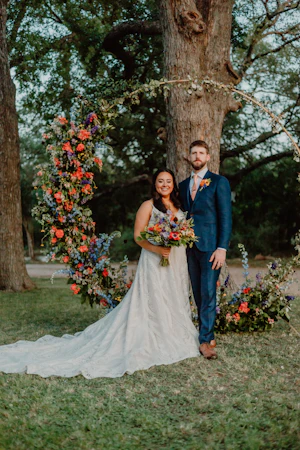 Groom Posing With Bride In Boho Lace Wedding Dress Called Roxanne By Sottero And Midgley With Colorful Flowers