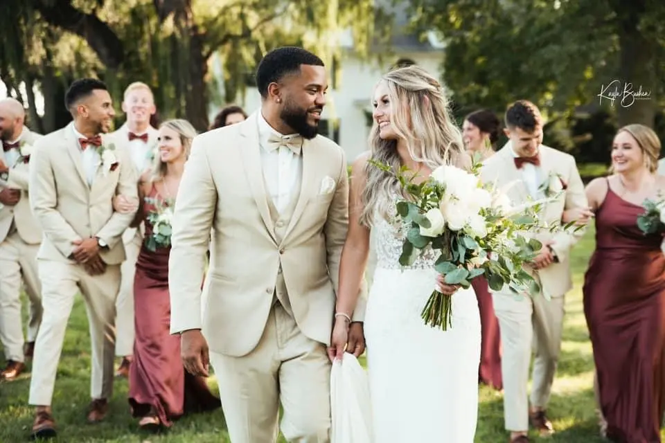Bride with groom wearing sexy v back sheath wedding dress