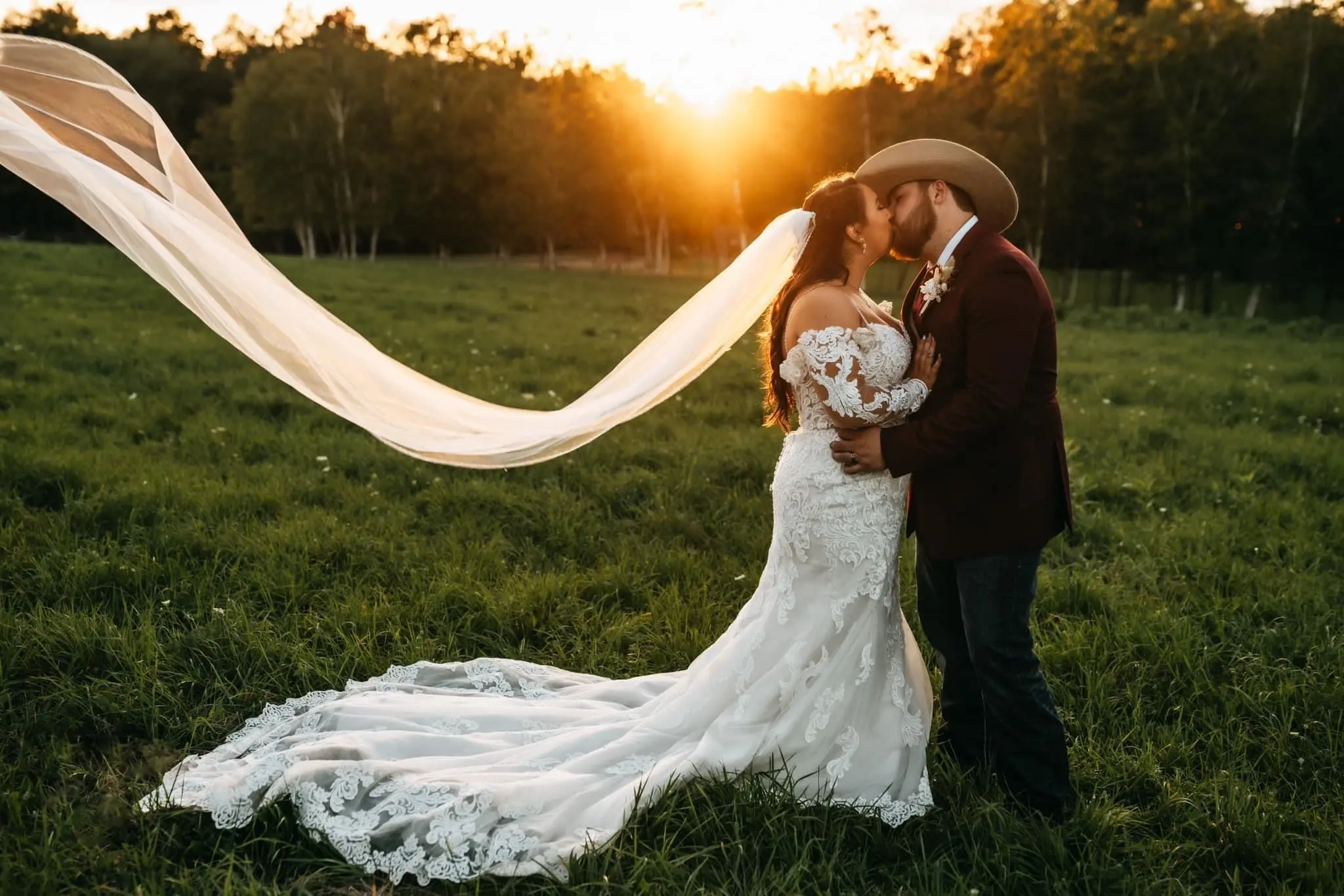 Bride wearing Fiona by Maggie Sottero while kissing her husband