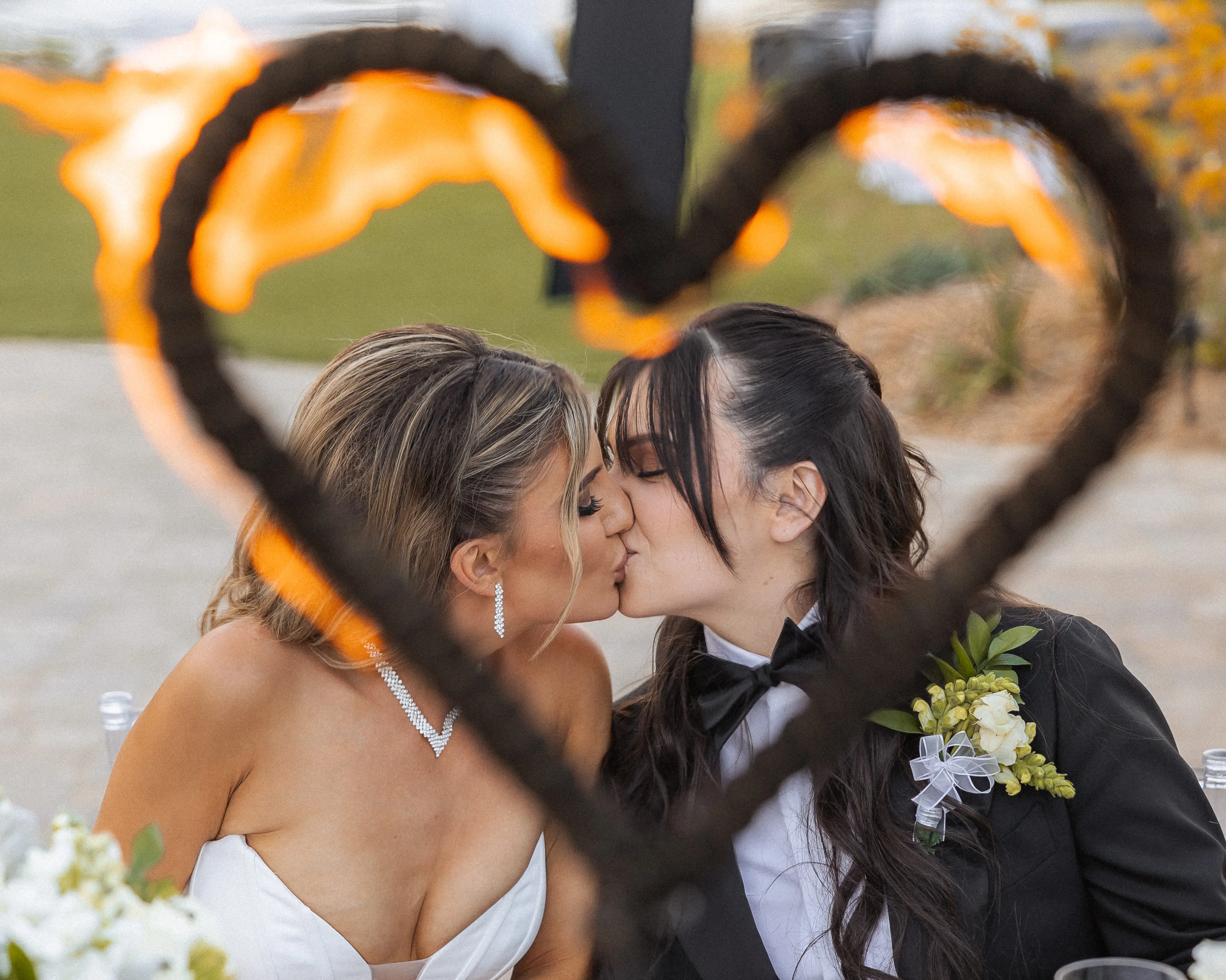 Bride wearing Derrick by Maggie Sottero kissing her partner
