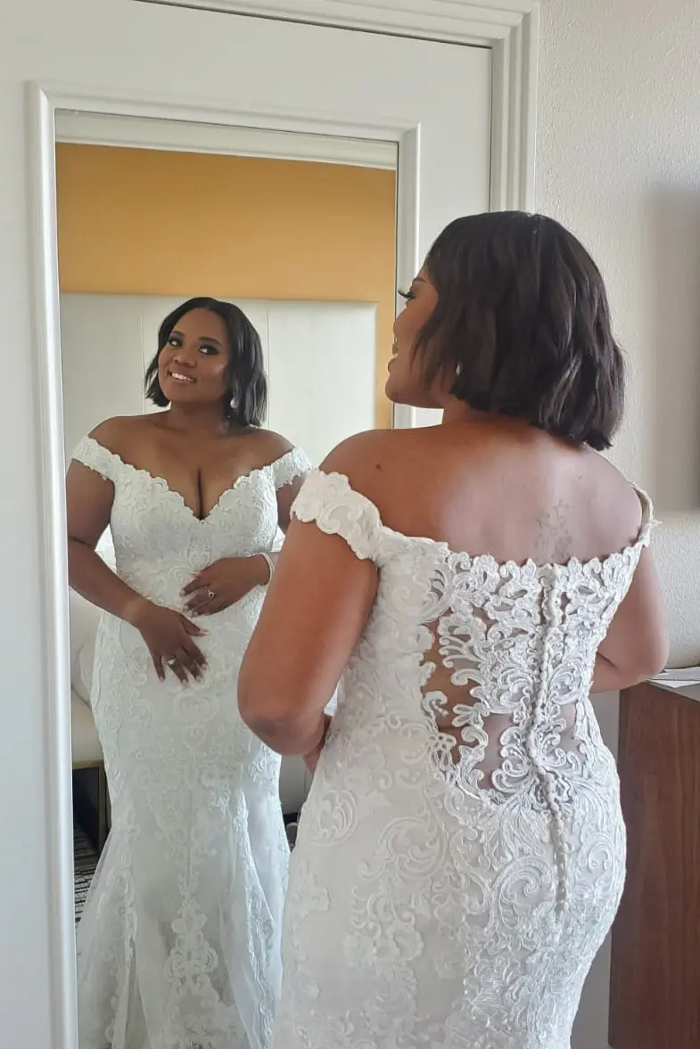 Bride wearing off the shoulder lace wedding dress