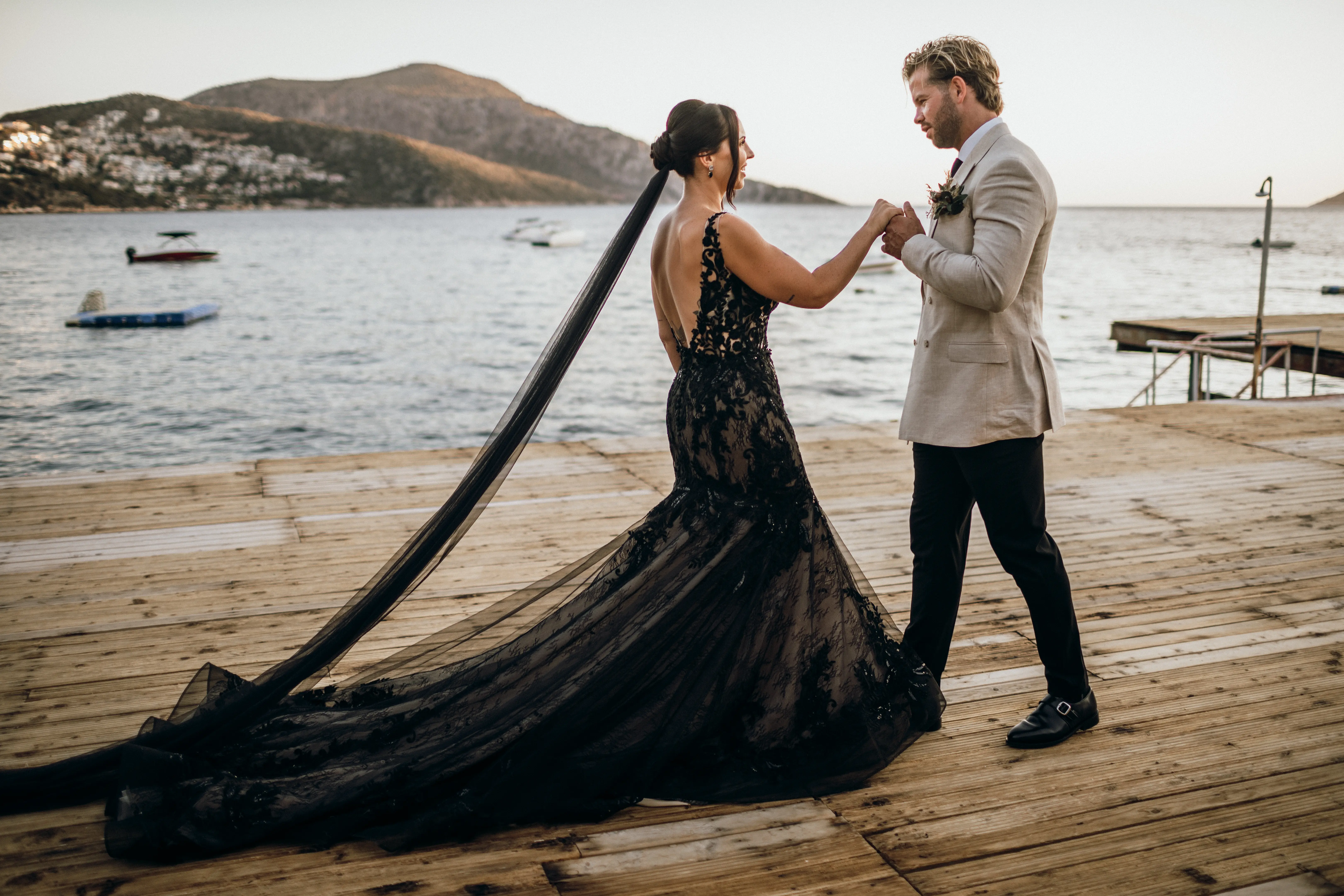 Bride Wearing Black Fit And Flare Wedding Dress Called Zander Lane By Sottero And Midgley With Groom On A Pier