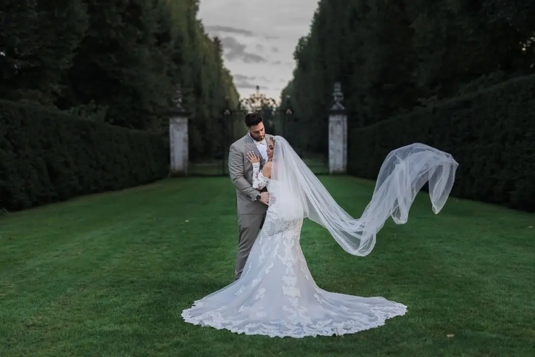 Bride Wearing Sparkly Fit-And-Flare Wedding Dress Called Fiona By Maggie Sottero With Groom