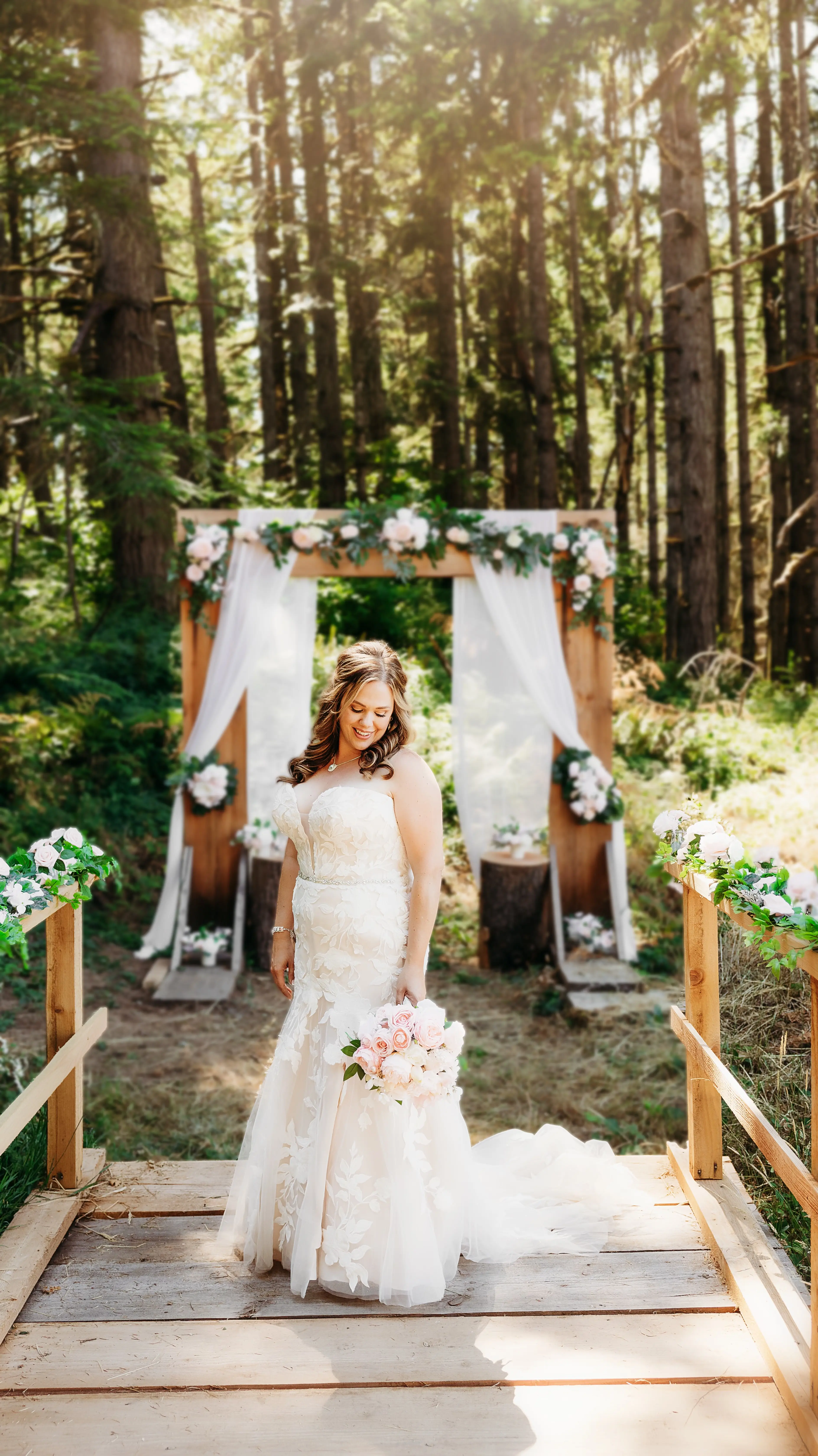 Bride wearing Hattie wedding dress by Rebecca Ingram in front of arch