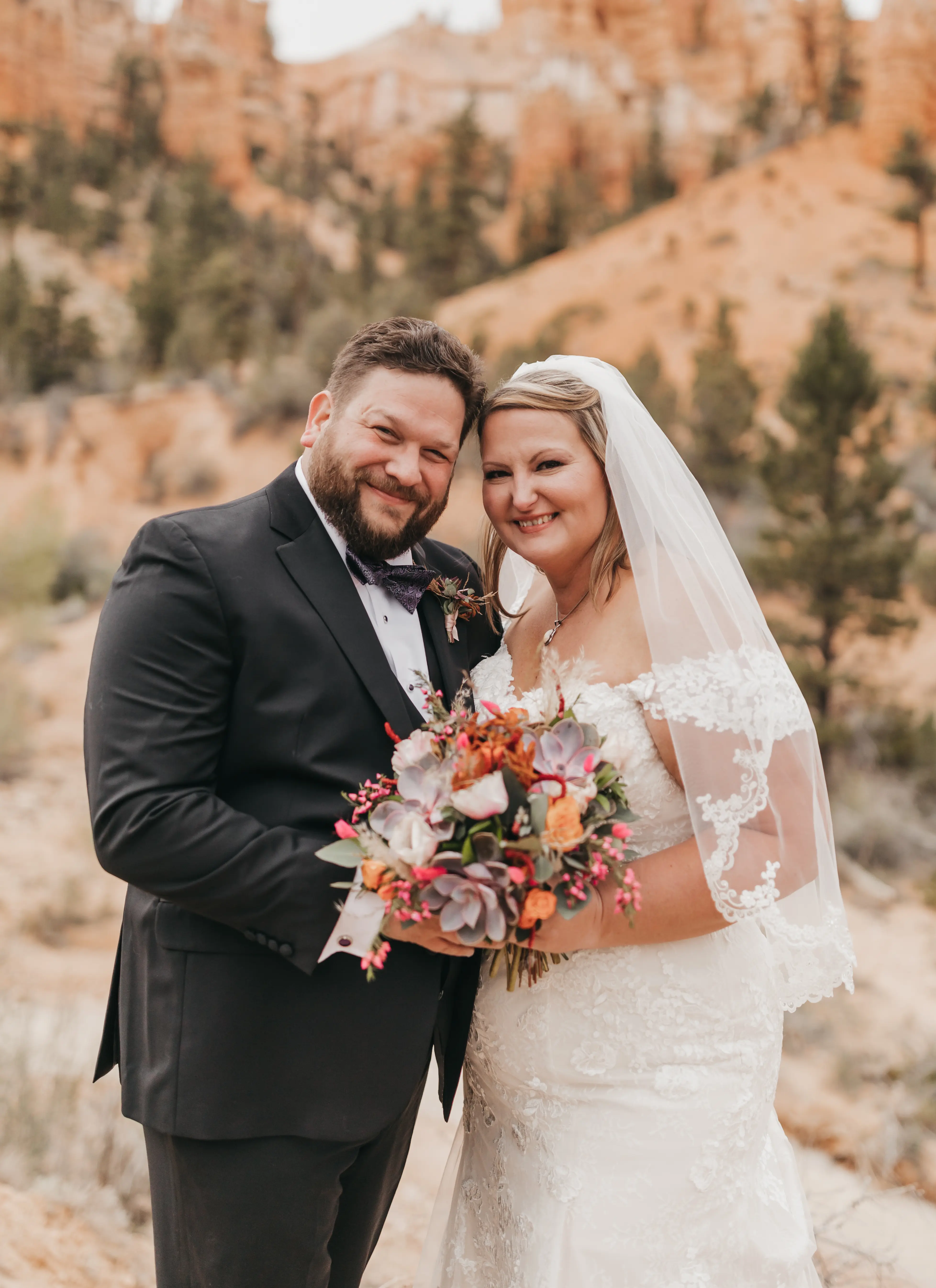 bride with groom in corset back fit and flare wedding dress
