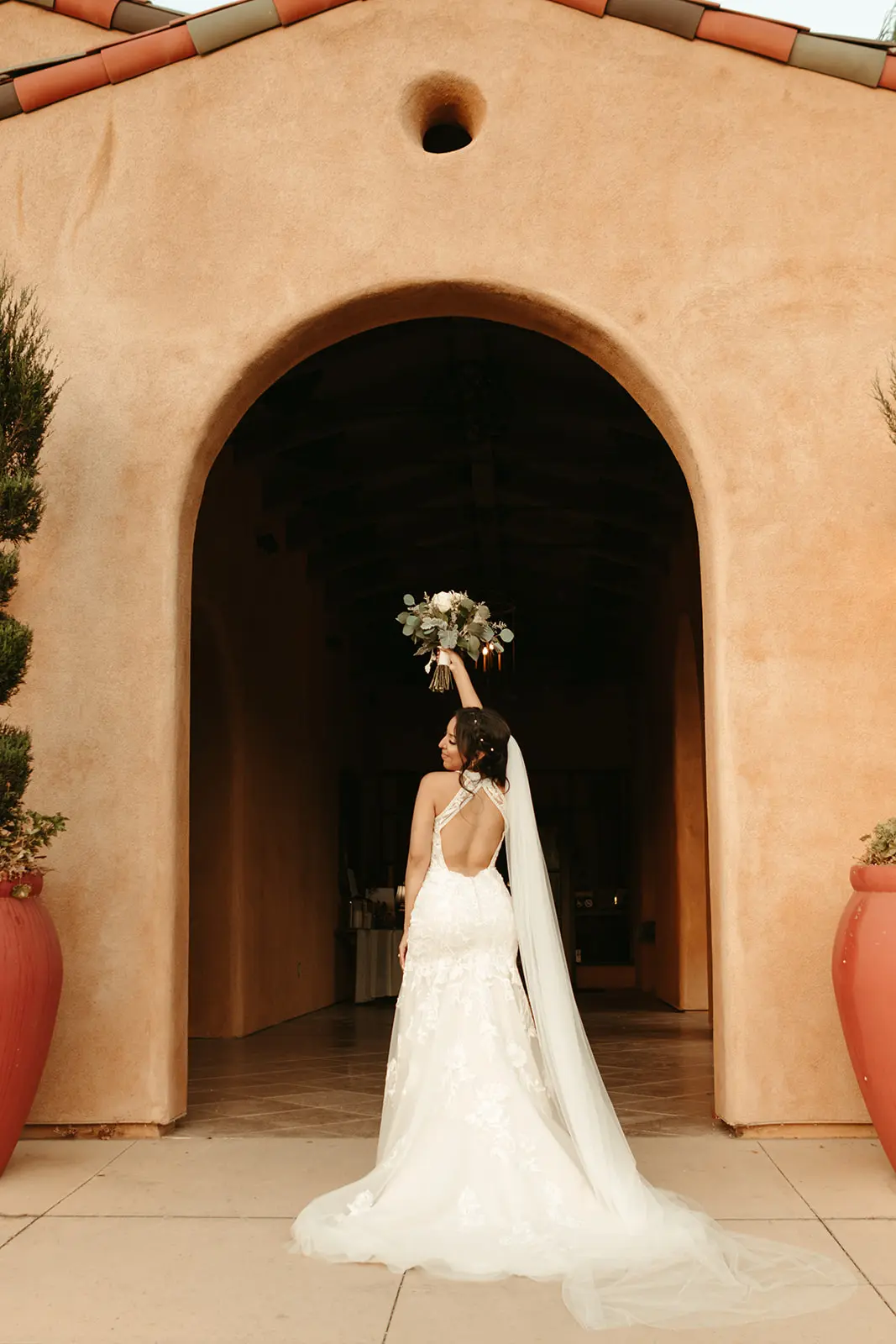Bride wearing backless wedding dress called Elizabetta.