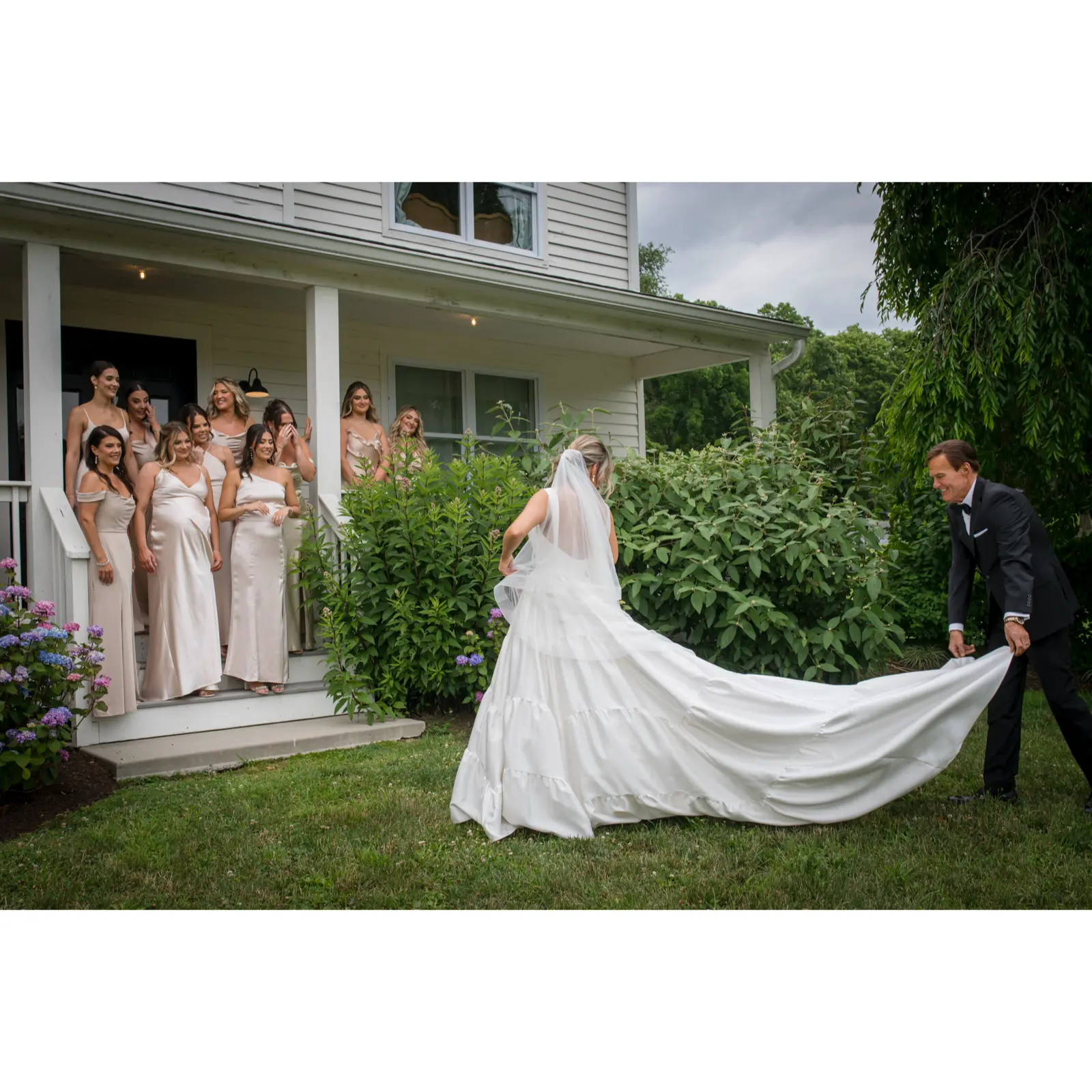 Bride wearing Talitha by Sottero and Midgley having her train fixed