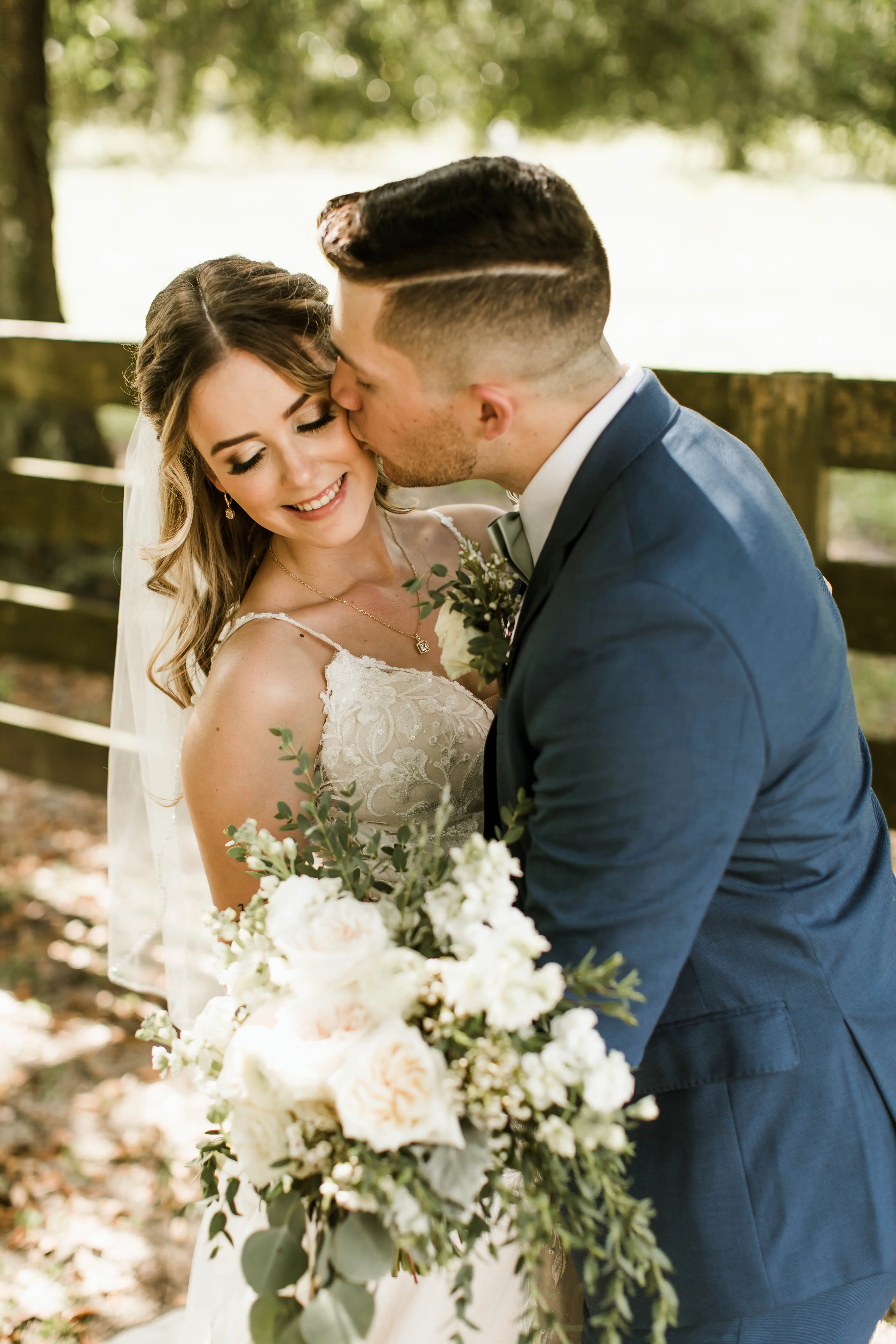 Bride with groom wearing affordable floral ballgown wedding dress.
