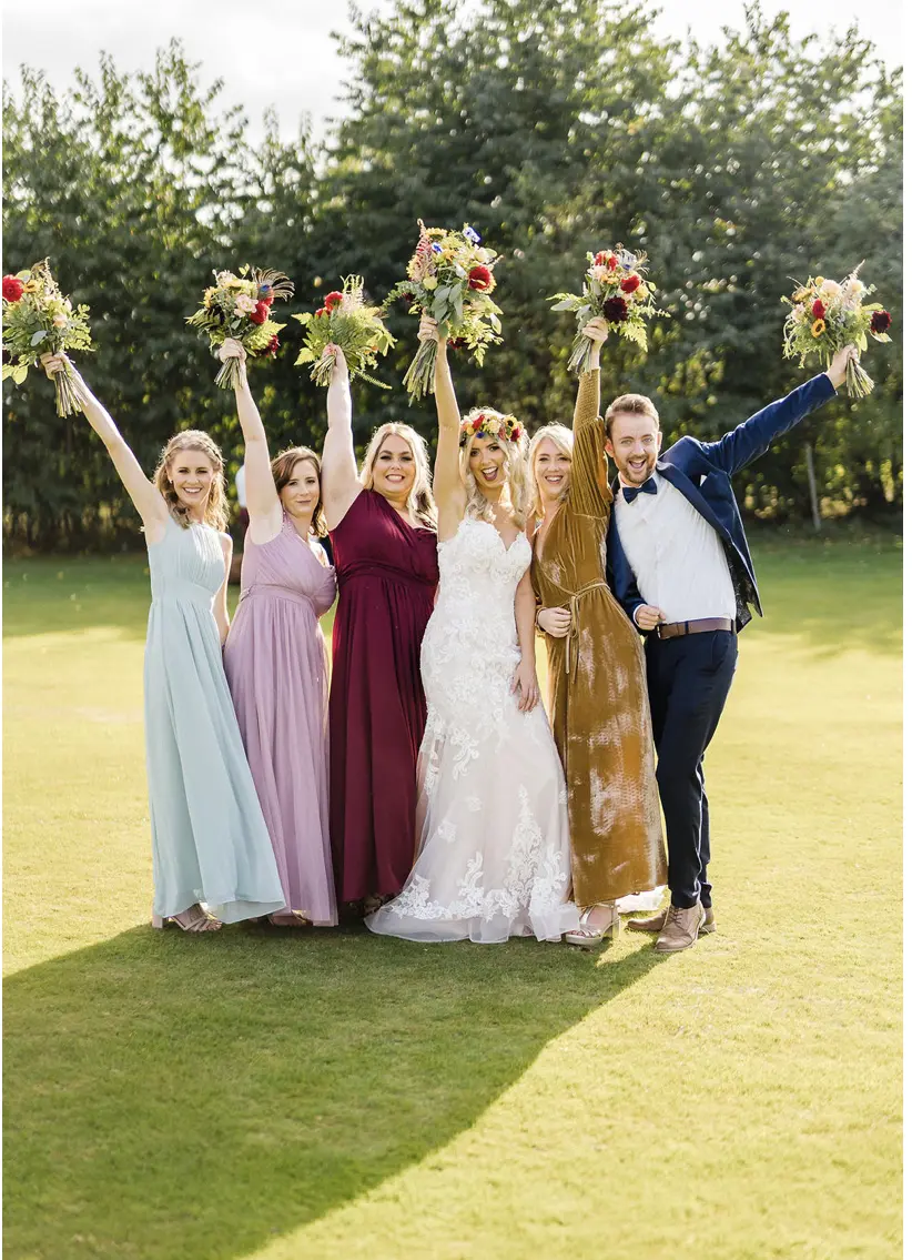 Bridal Party and Bride Wearing Elegant Fit-and-Flare Bridal Dress by Maggie Sottero