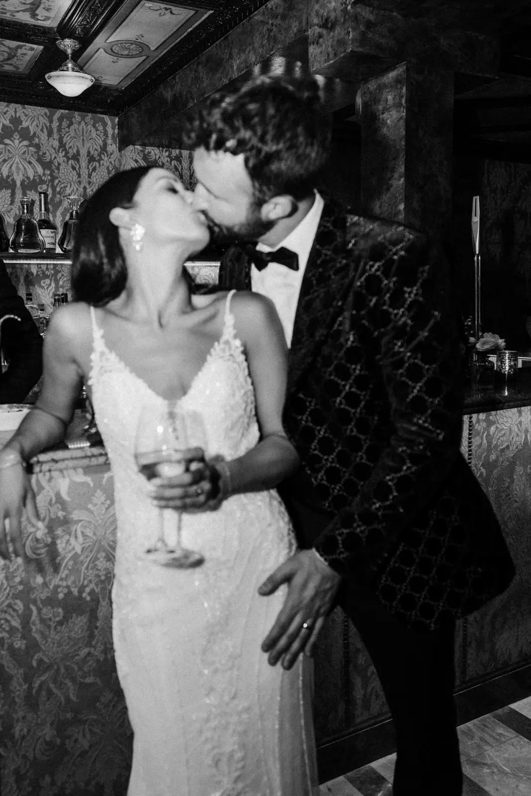 Groom Kisses Bride In Beaded Lace Sheath Bridal Gown Called Barrett By Sottero And Midgley