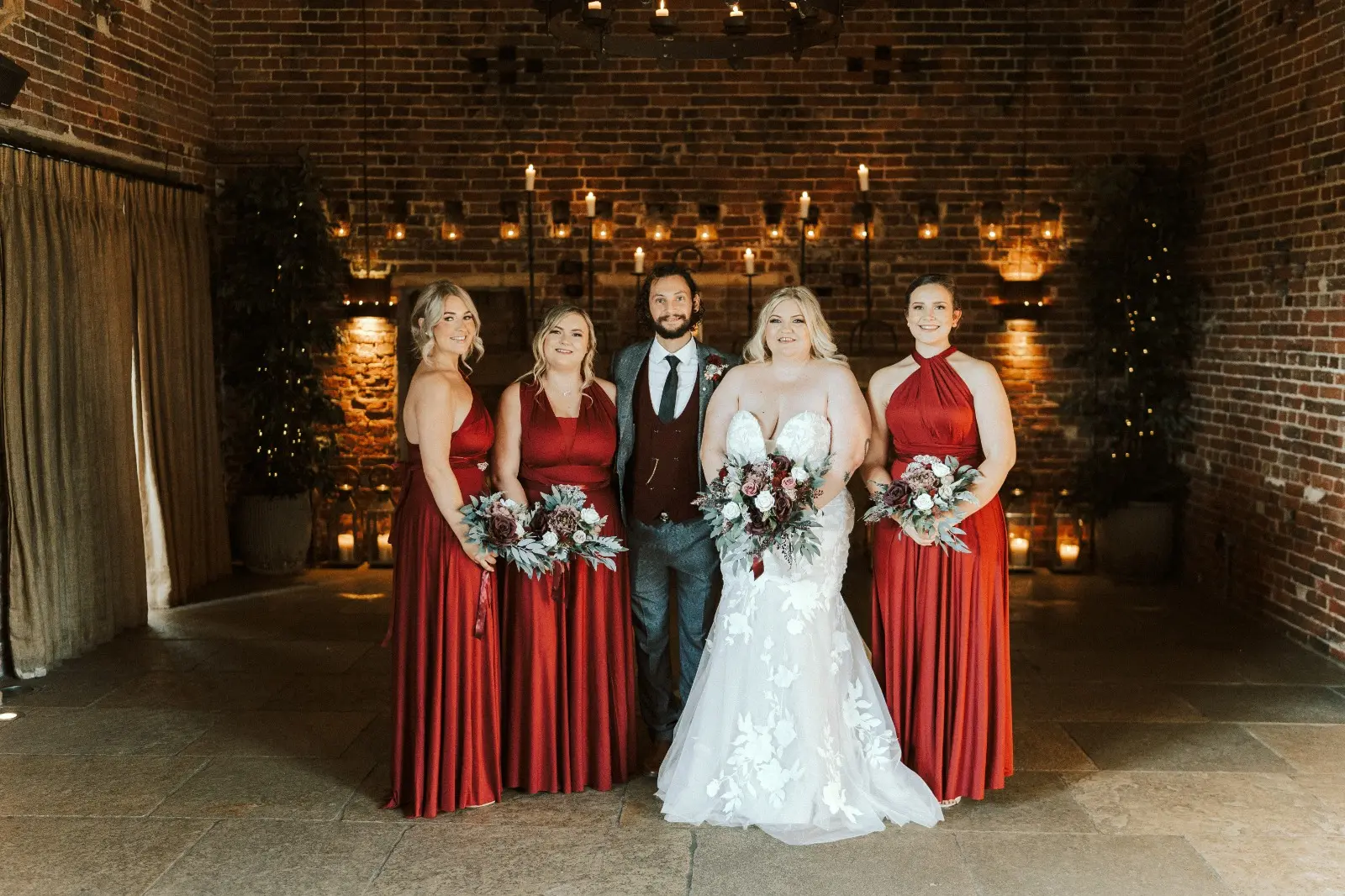 Bride Wearing Lace Mermaid Wedding Dress Called Hattie By Rebecca Ingram With Bridesmaids And Groom