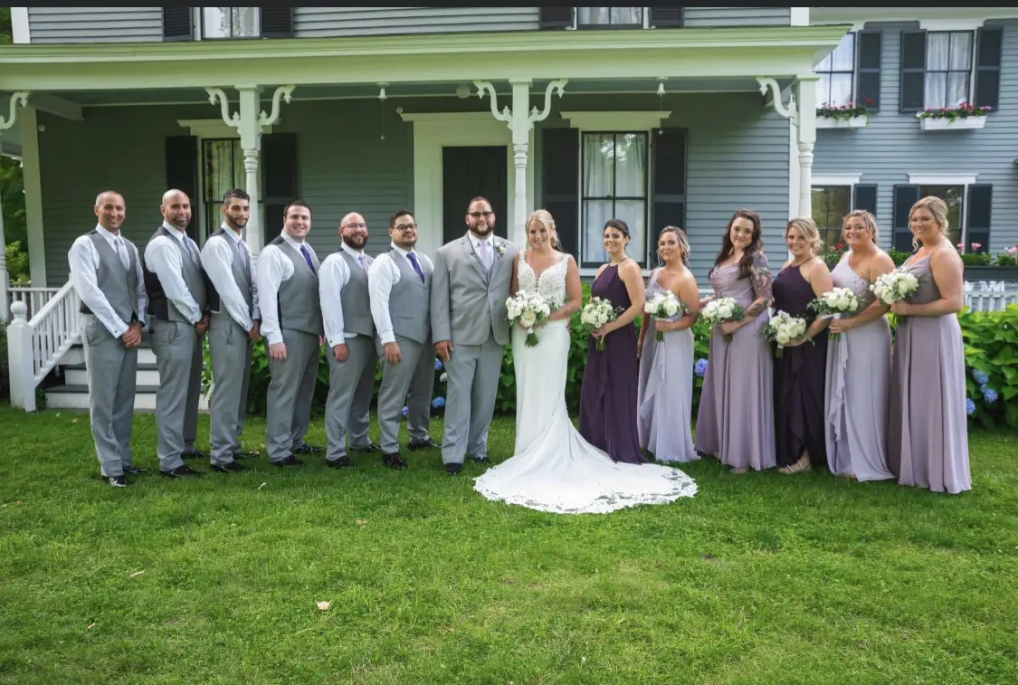 Bride with groom wearing lace crepe wedding dress