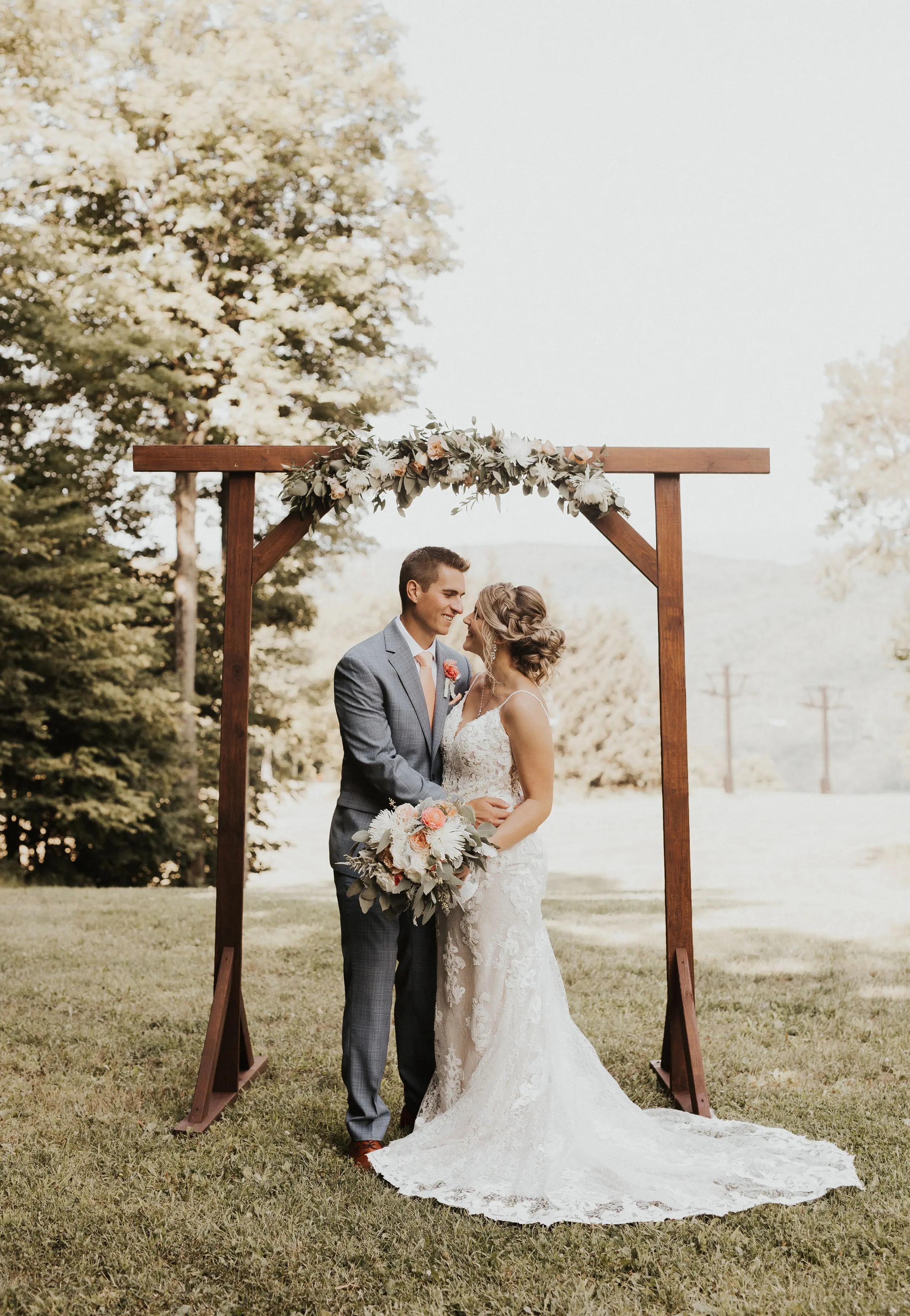 Bride Wearing Lace Sexy Wedding Dress Called Tuscany Lynette By Maggie Sottero With Groom At The Altar
