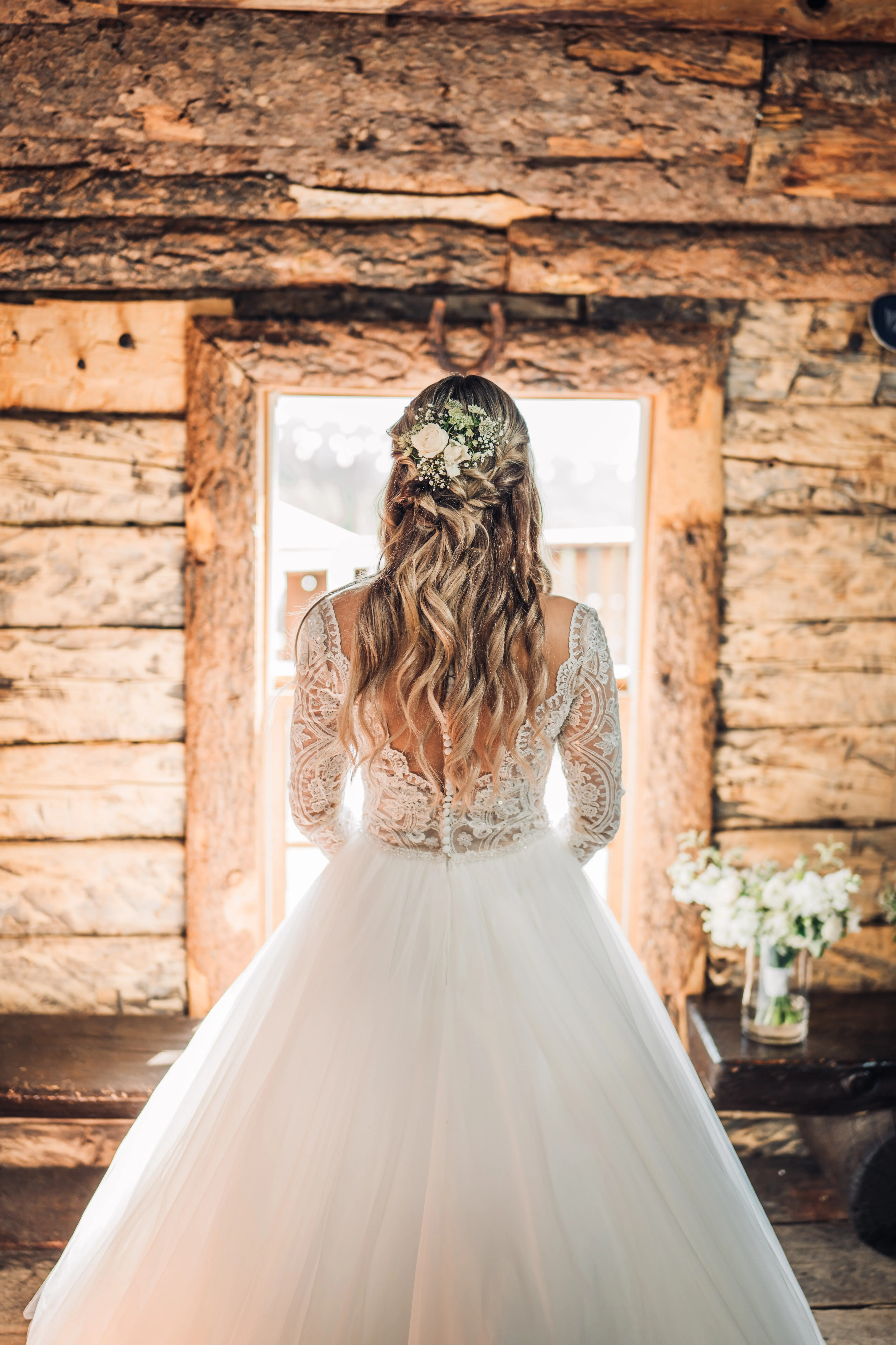 Bride wearing long sleeve lace ballgown wedding dress