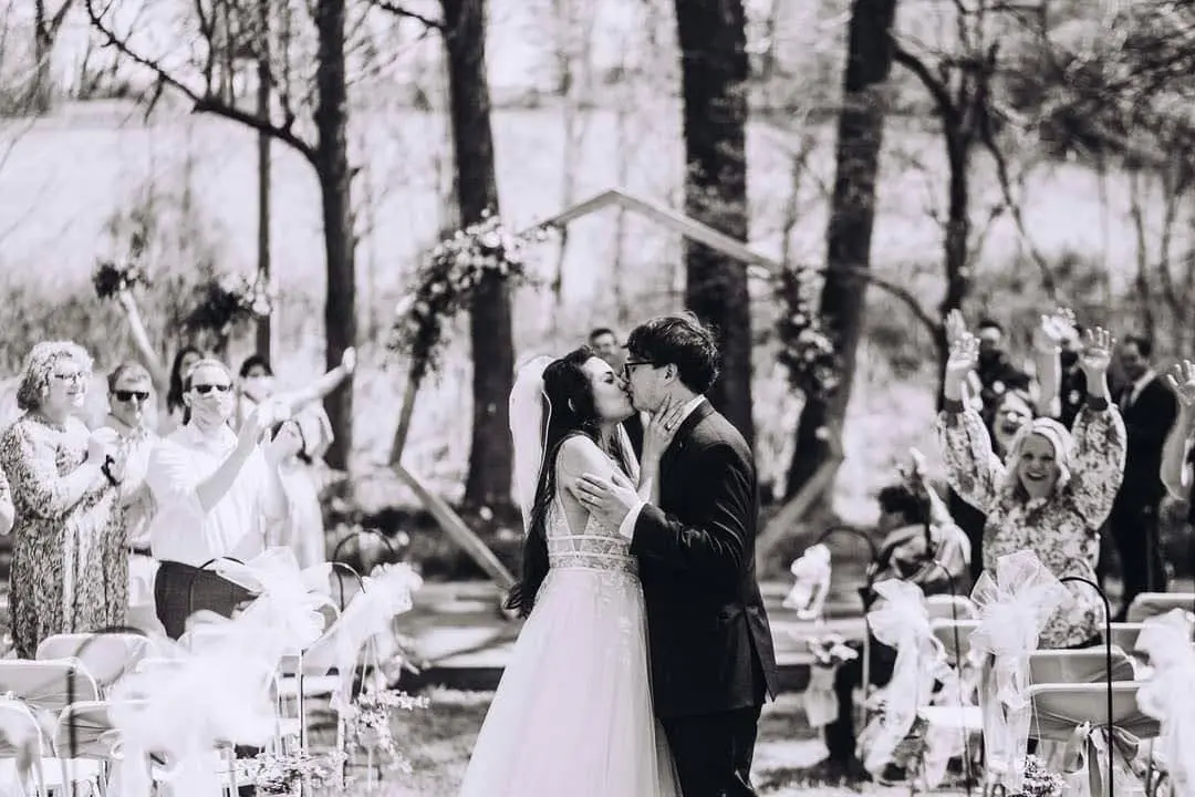 Groom With Bride Wearing Lace A-Line Wedding Dress Raelynn By Rebecca Ingram