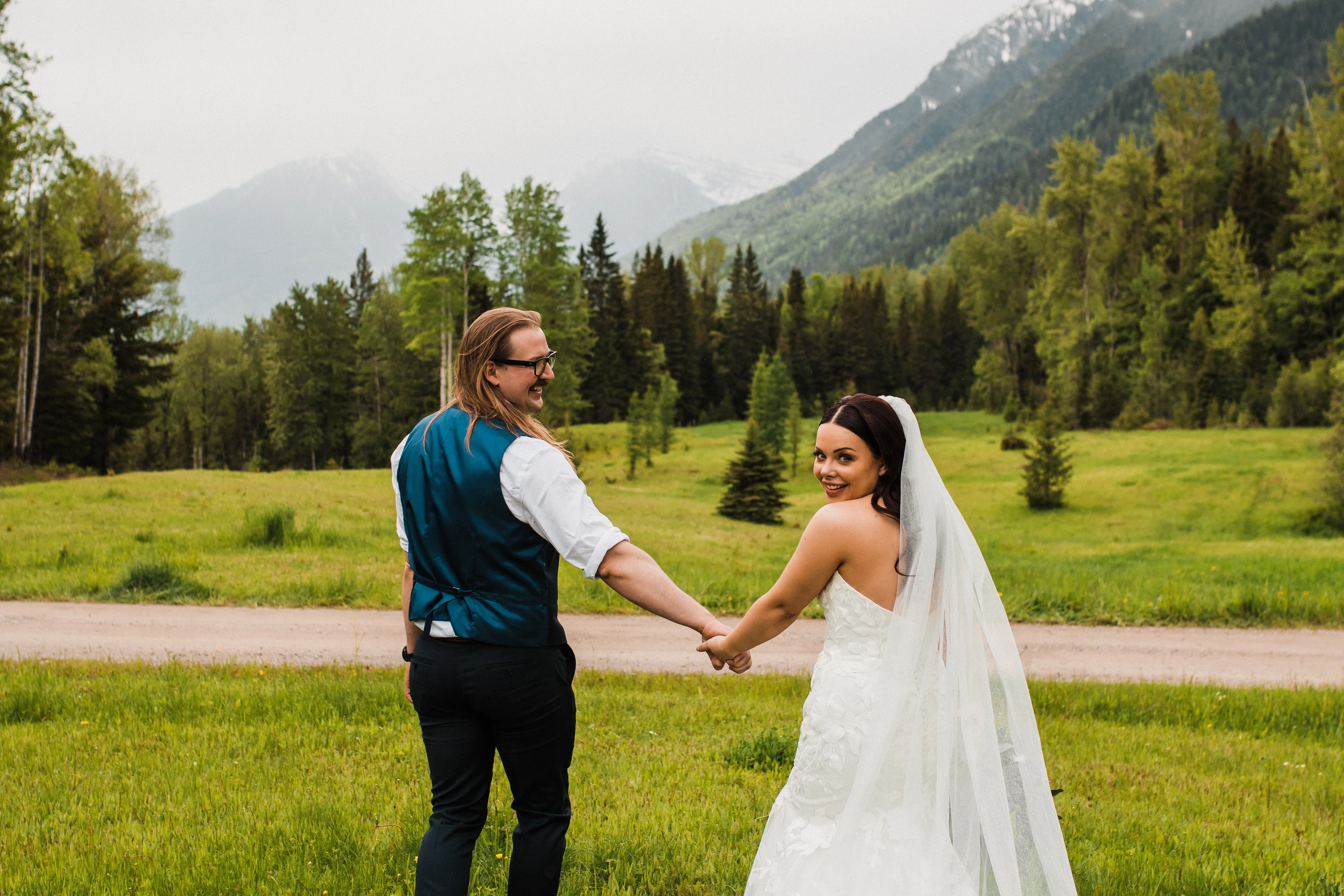Groom Holding Hands with Bride in Floral Fit-And-Flare Wedding Dress Called Hattie By Rebecca Ingram With Veil