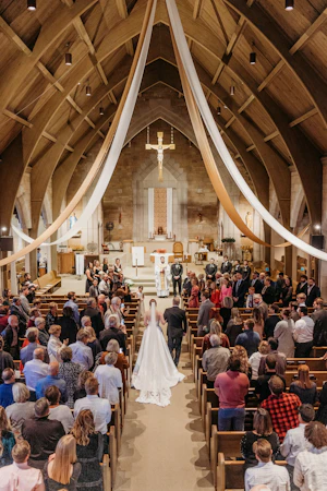 Real Bride Walking Down The Aisle In a Church Wearing A White Wedding Dress Named Selena By Maggie Sottero