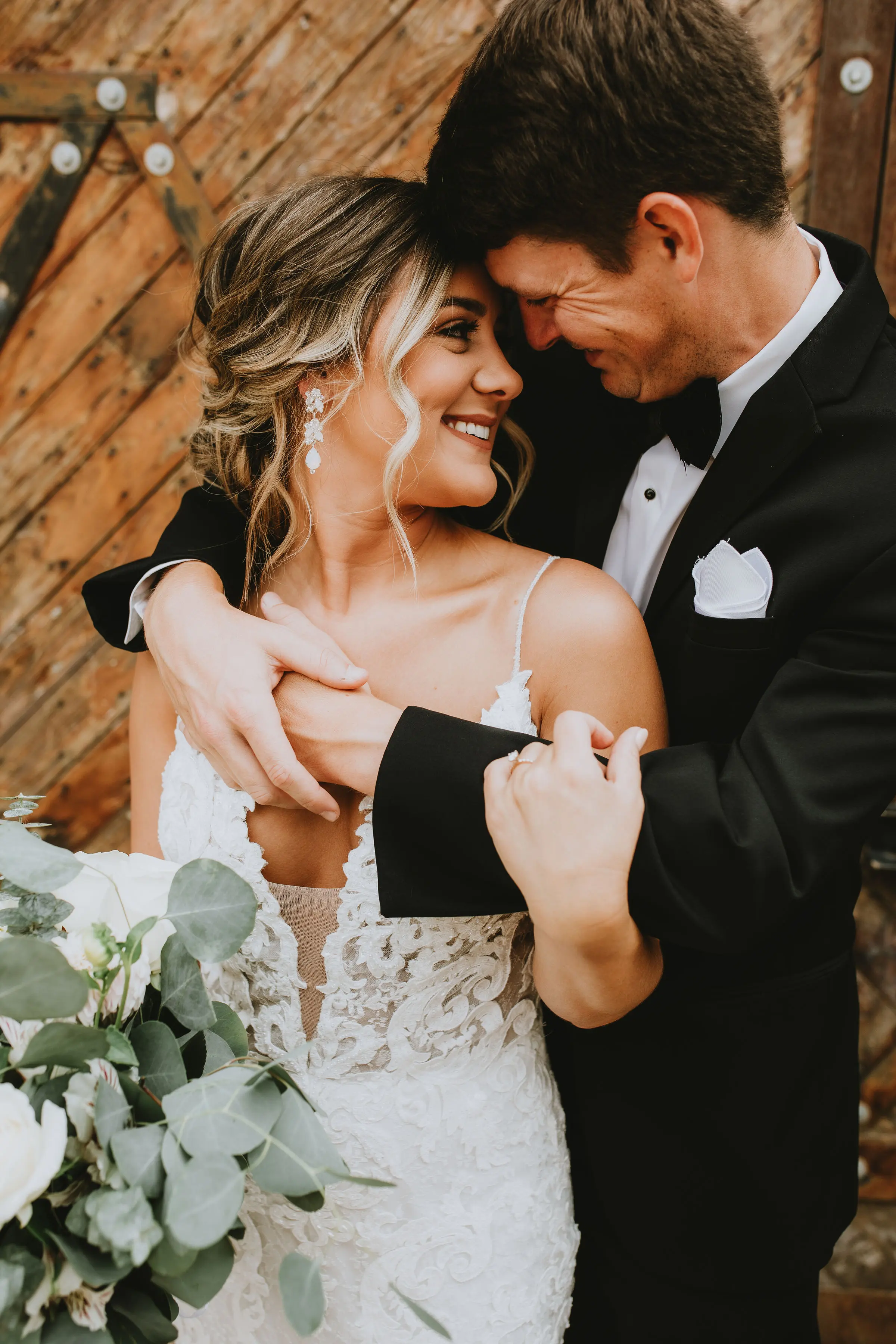 Bride with groom in romantic lace sheath wedding dress