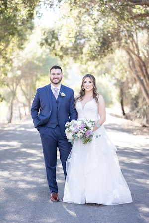 Groom With Bride Wearing Lace Wedding Dress With Tiered Tulle Skirt Lettie By Rebecca Ingram