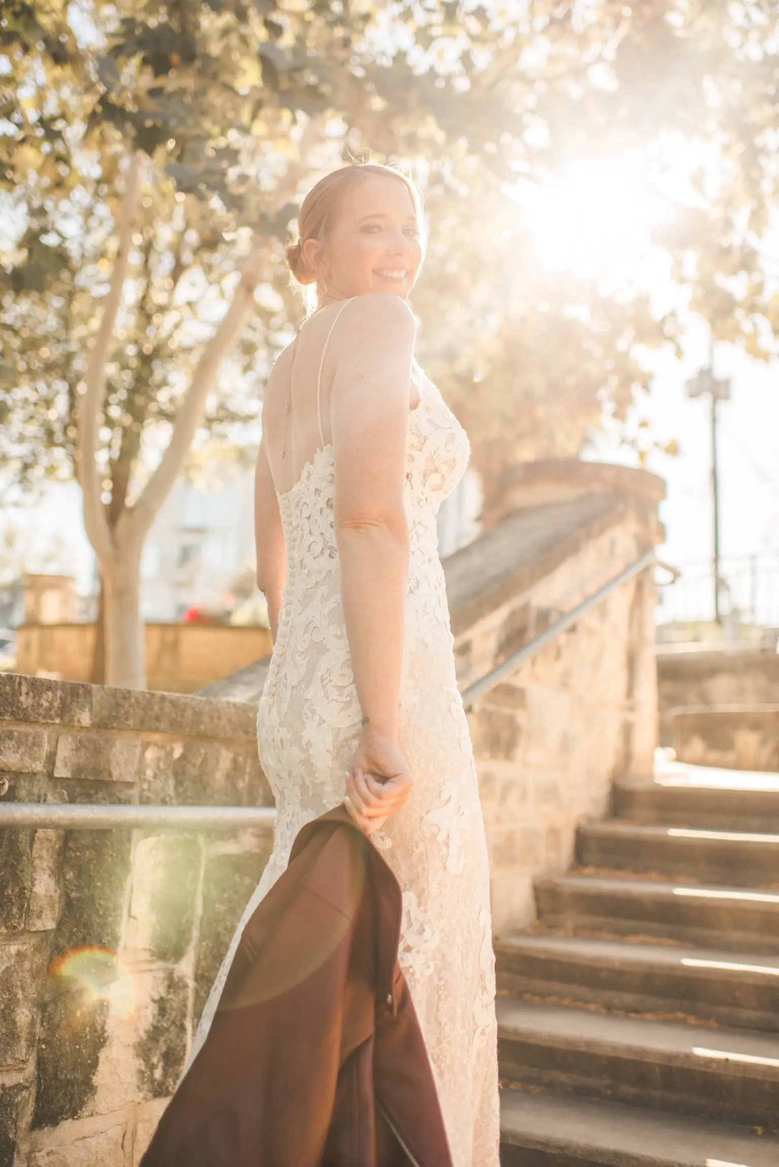Bride Wearing Glamorous Lace And Sequin Wedding Dress Called Tuscany By Maggie Sottero Showing Back In Sunlight
