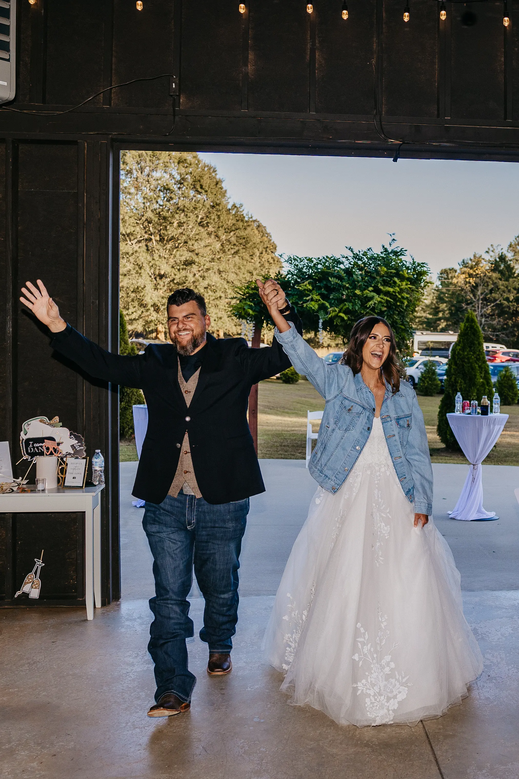 Bride wearing Harlem wedding dress by Maggie Sottero entering reception with her husband
