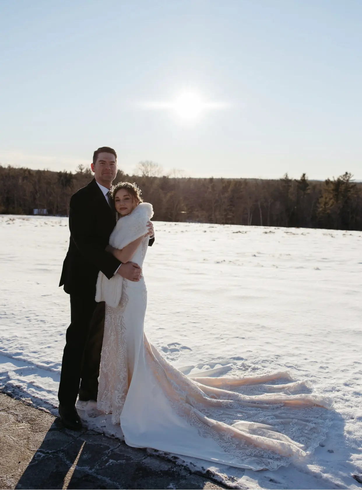 Bride Wearing Lace Halter Wedding Gown Called Kevyn By Sottero And Midgley With Groom In The Snow