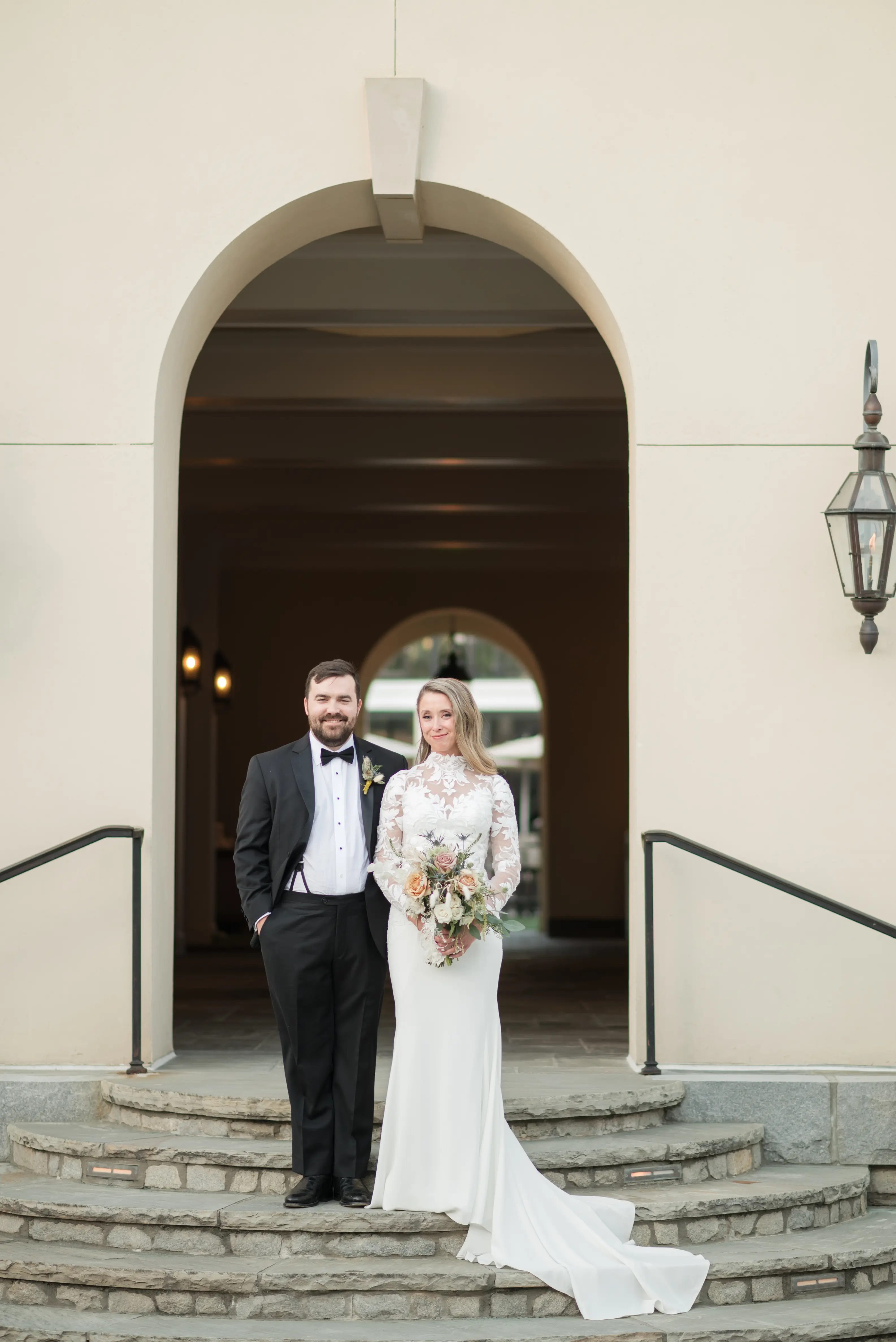 Bride wearing Dionne wedding dress by Rebecca Ingram standing with her husband