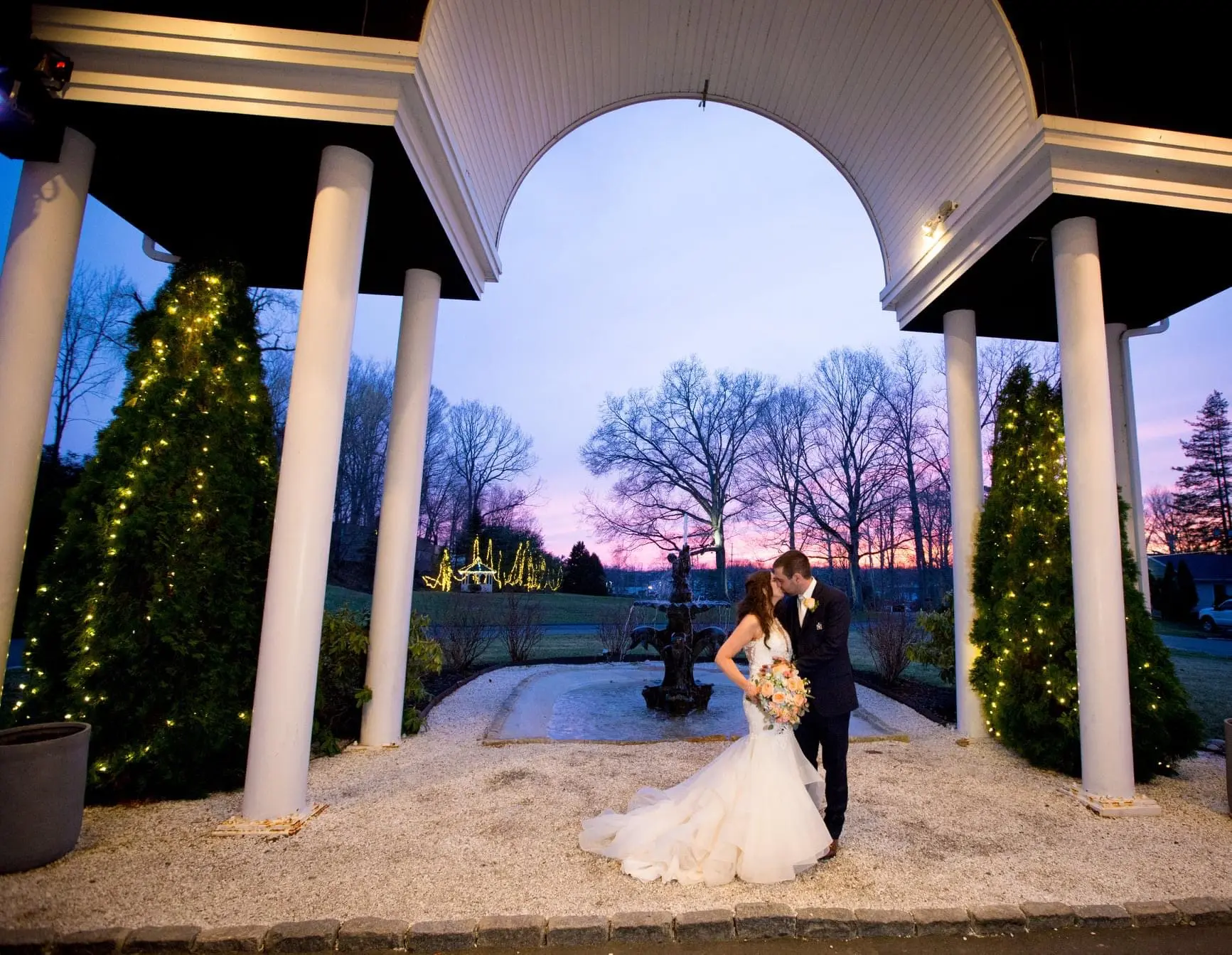 Bride with groom wearing organza mermaid wedding dress