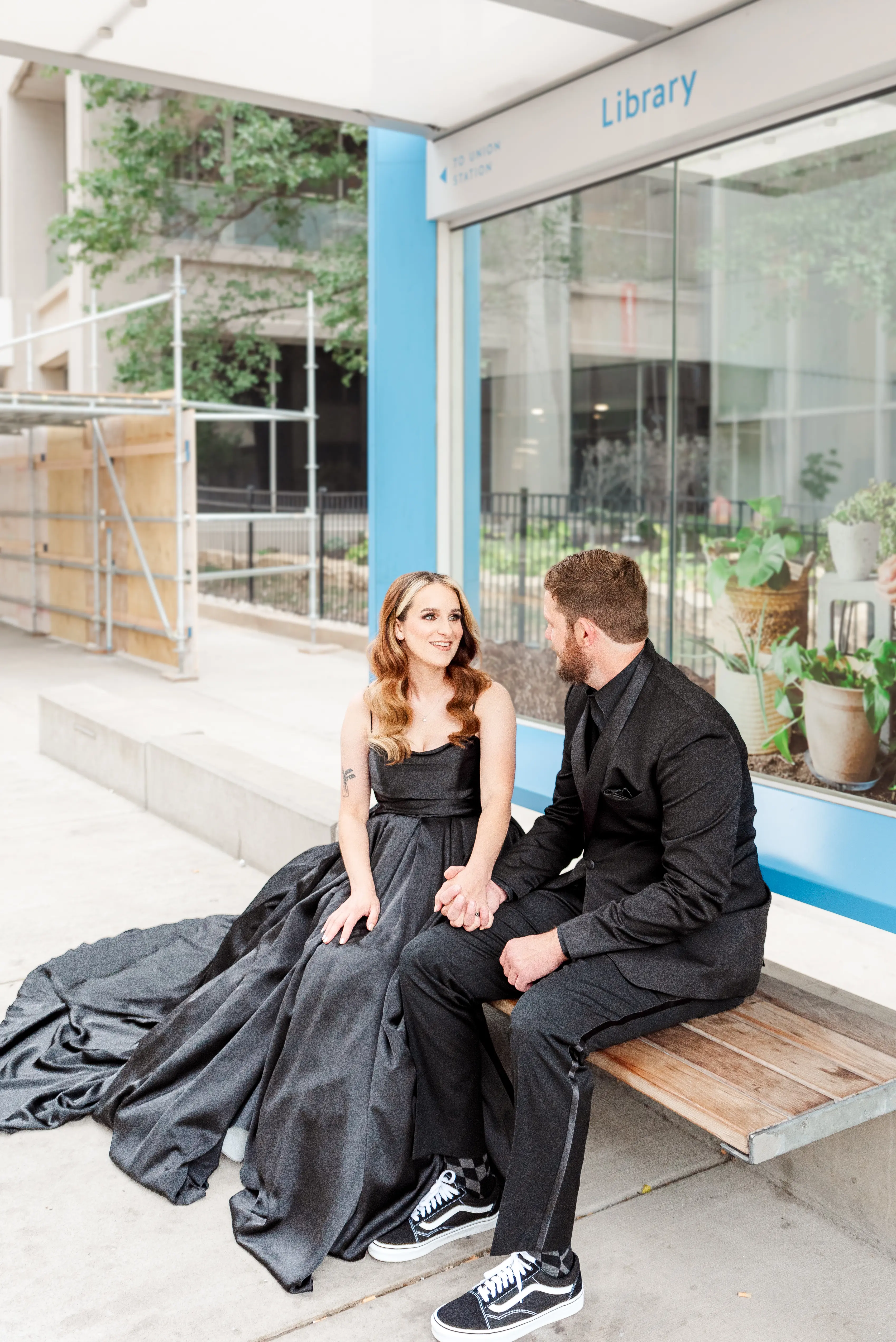 Bride wearing Scarlet wedding dress by Maggie Sottero while holding hands with her husband