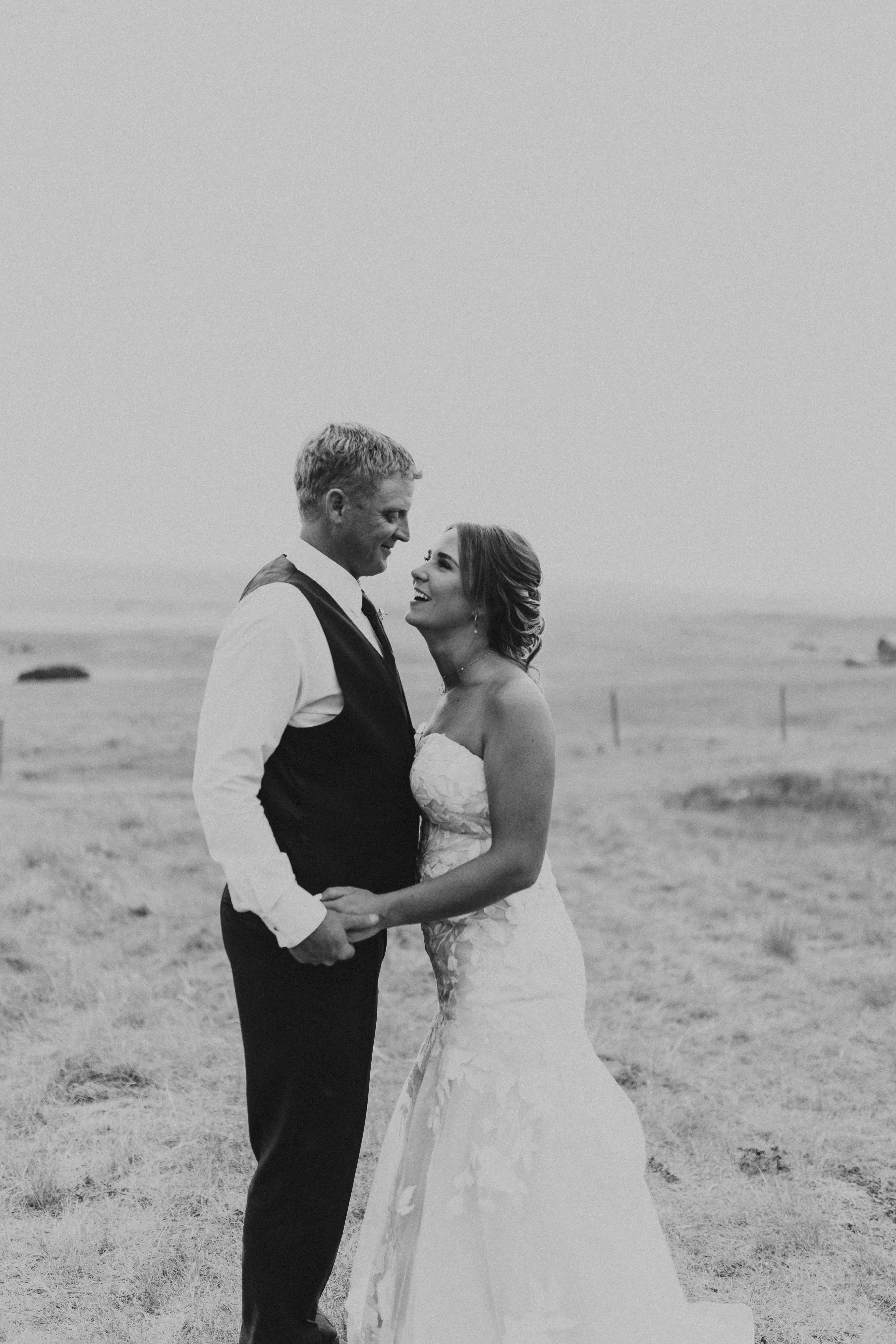 Bride with groom wearing strapless mermaid wedding dress