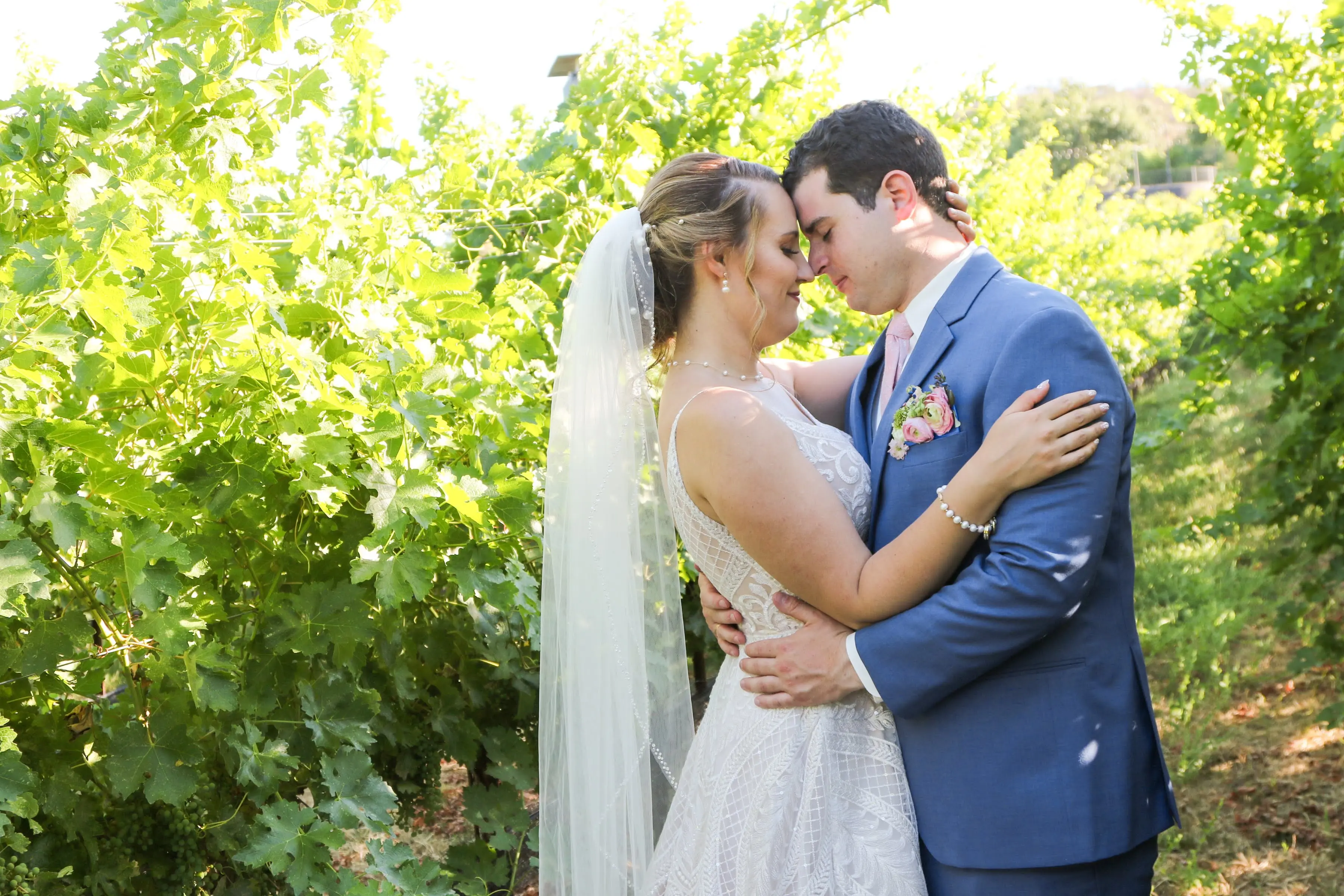 bride in beaded lace spaghetti strap wedding dress called roxanne by sottero and midgley
