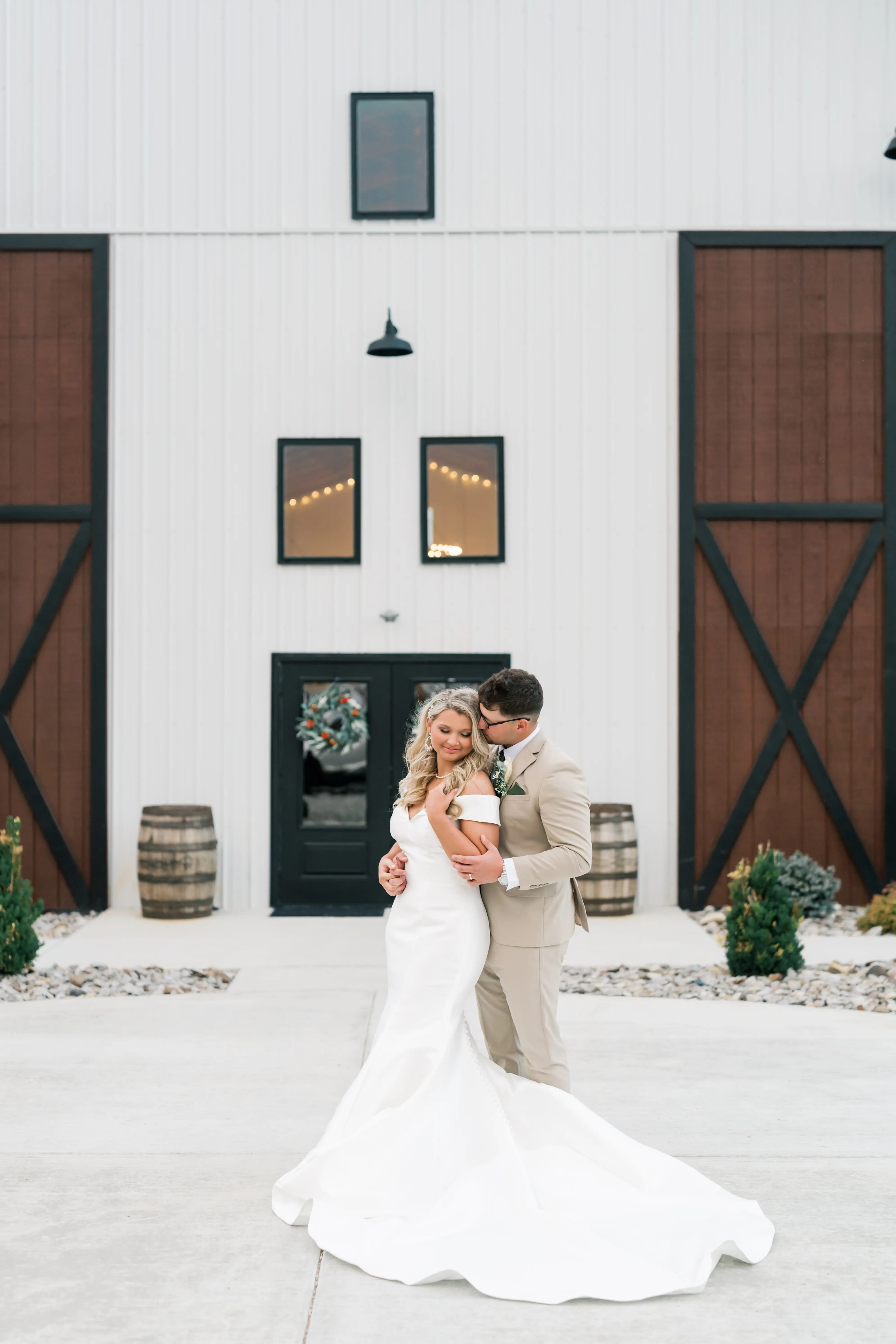 Bride wearing Josie wedding dress by Rebecca Ingram cuddling up to her husband