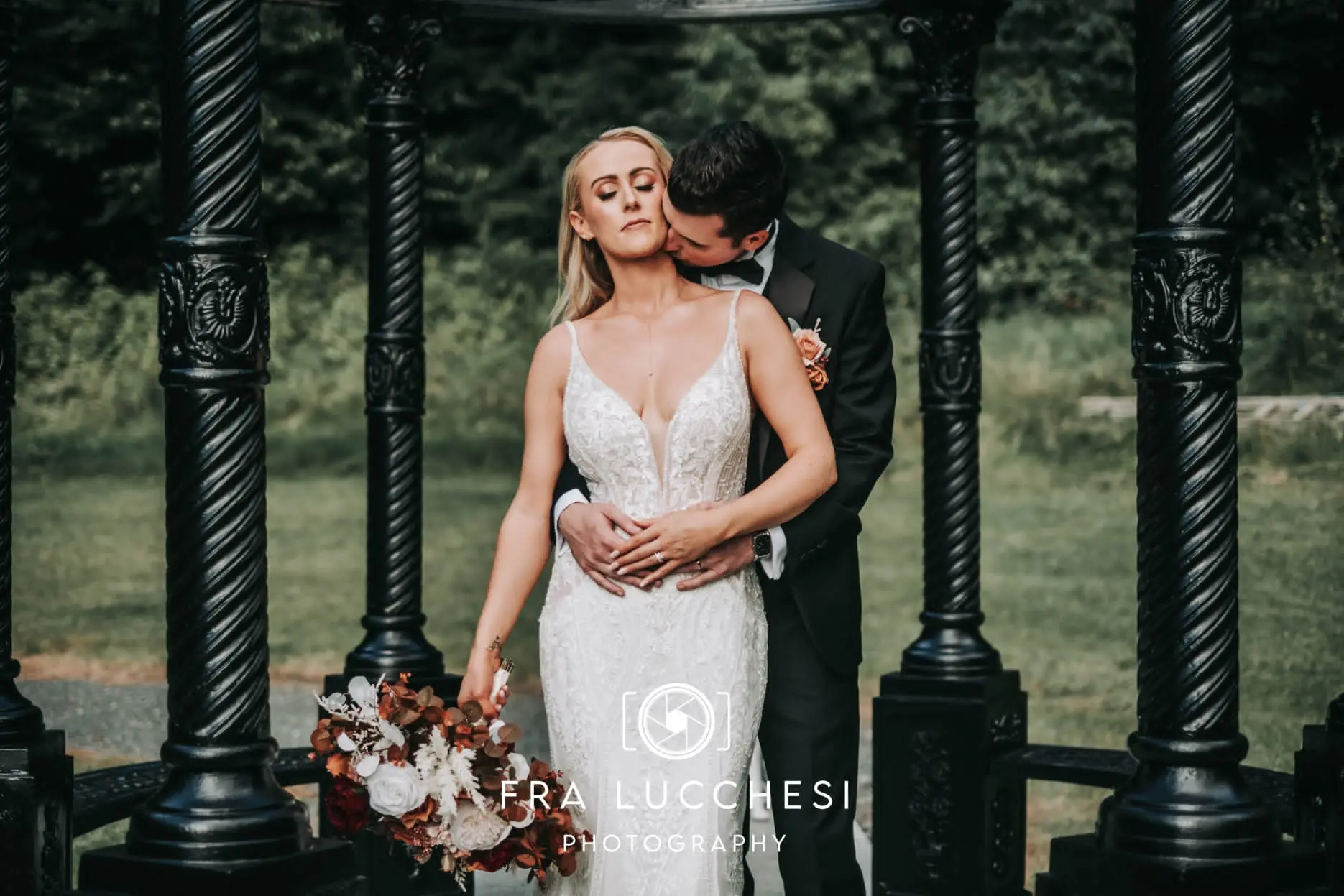 Bride wearing Bailey wedding dress by Sottero and Midgley being kissed by her husband